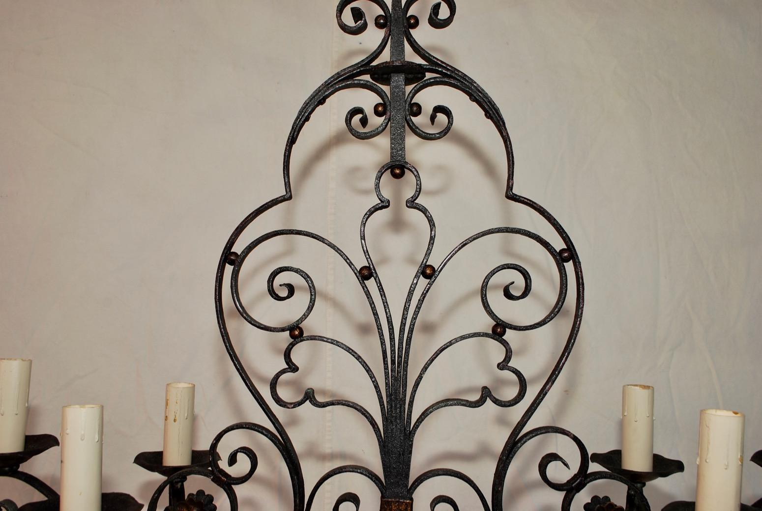 An elegant French wrought iron chandelier, it might be Maison Baguès, the patina is much nicer in person.

 