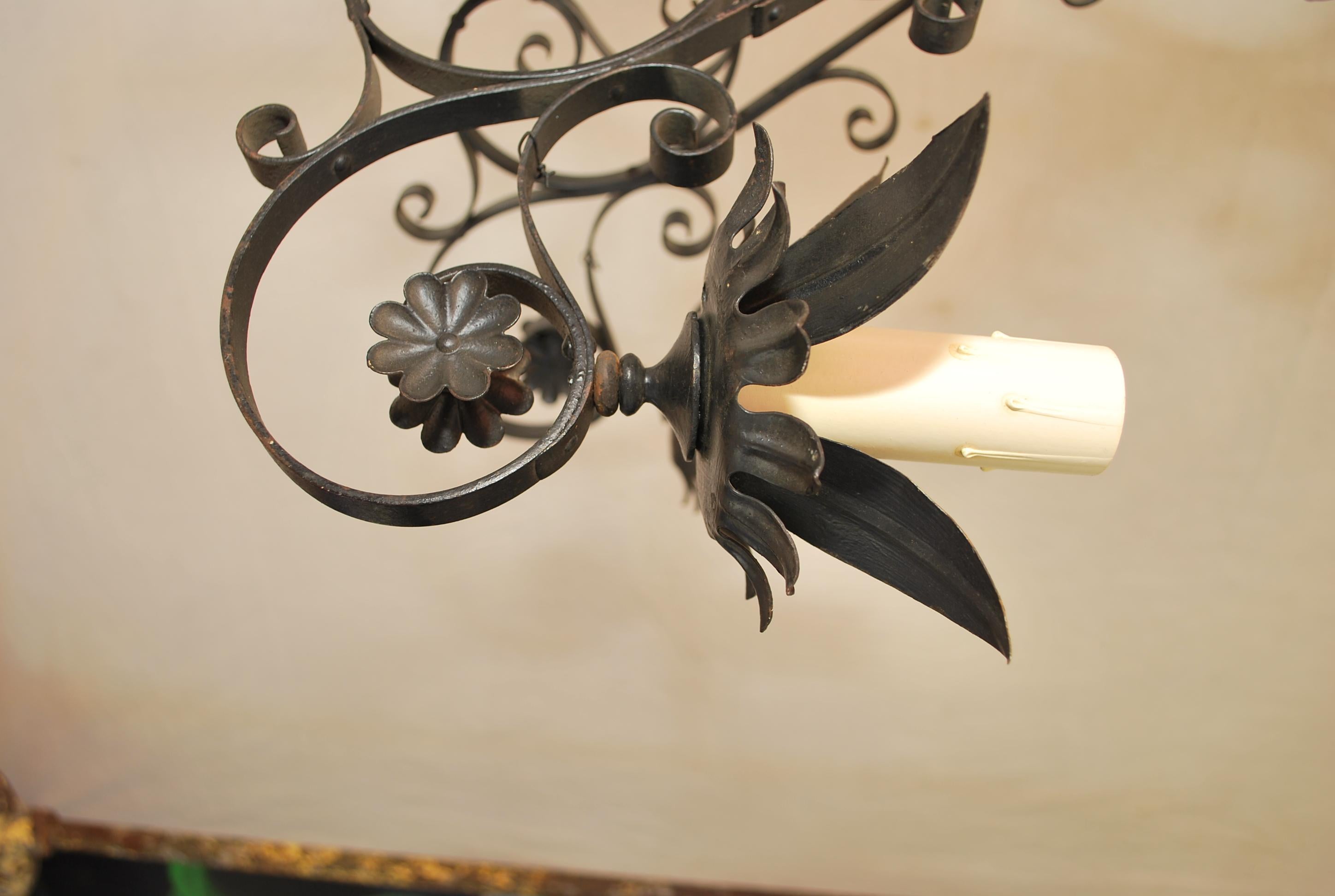 An elegant all hands forged wrought iron chandelier, the patina is much nicer in person