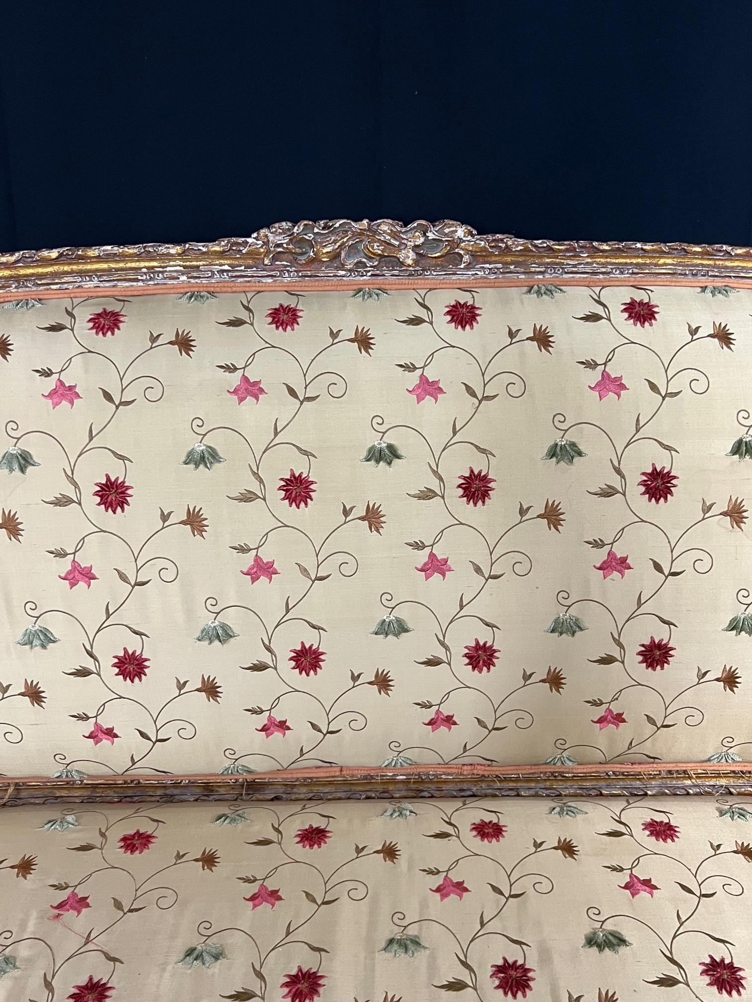 Lovely 19th Century French sofa with original gold gilt intact. Reupholstered in silk brocade fabric, all in excellent shape except for minor tears in easily replaceable back which is upholstered in peach silk. Gold gilt has not been touched up but