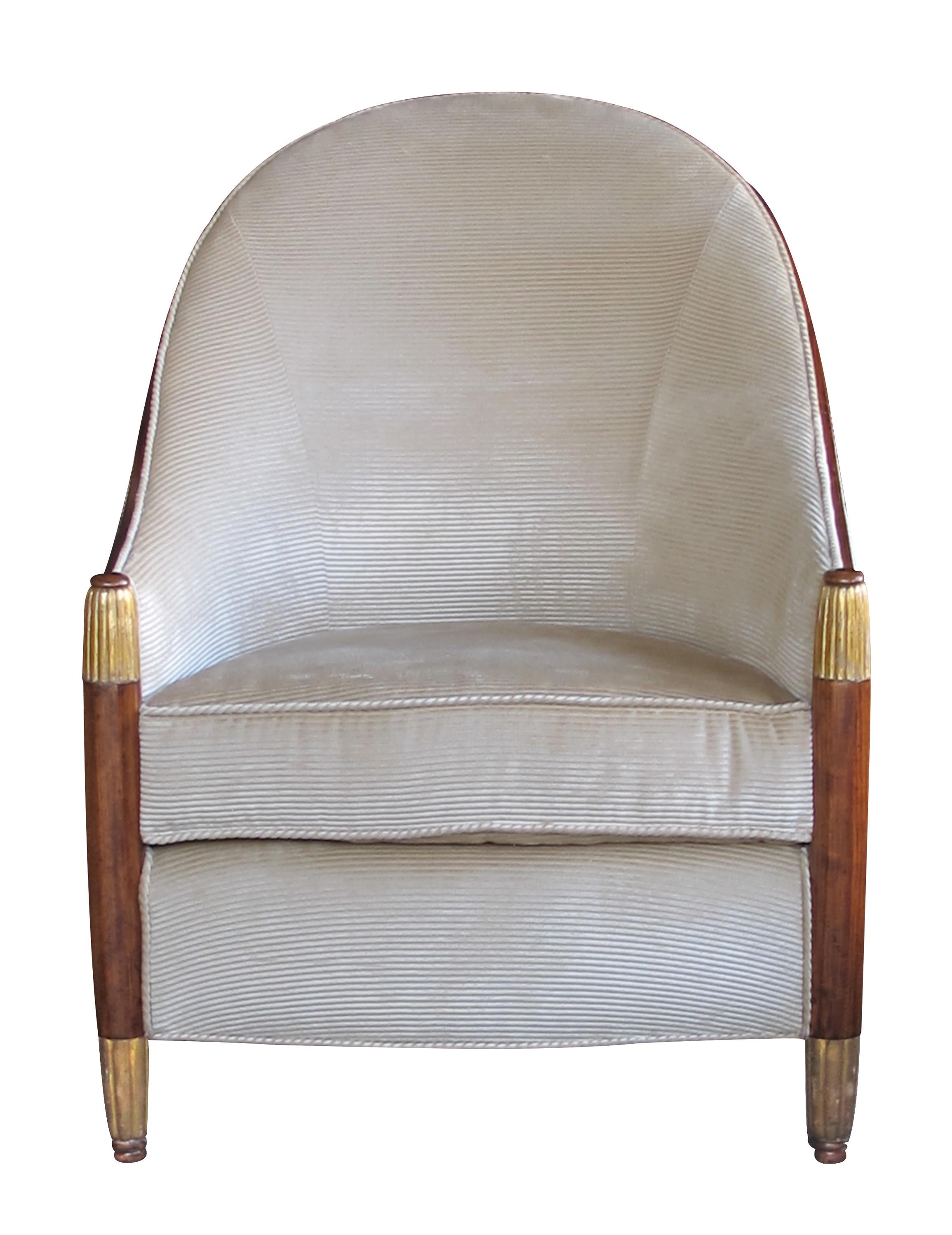 Art Deco at its chicest; the high arching back sweeps down to faceted supports with reeded gilt caps and feet.