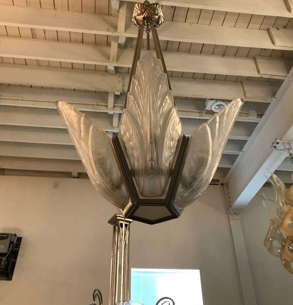Elegant French Art Deco chandelier signed by Des Hanots. With five clear frosted glass panels having geometric motif. Polished details on a silvered nickel frame with a streamline design. Has been rewired for American use.