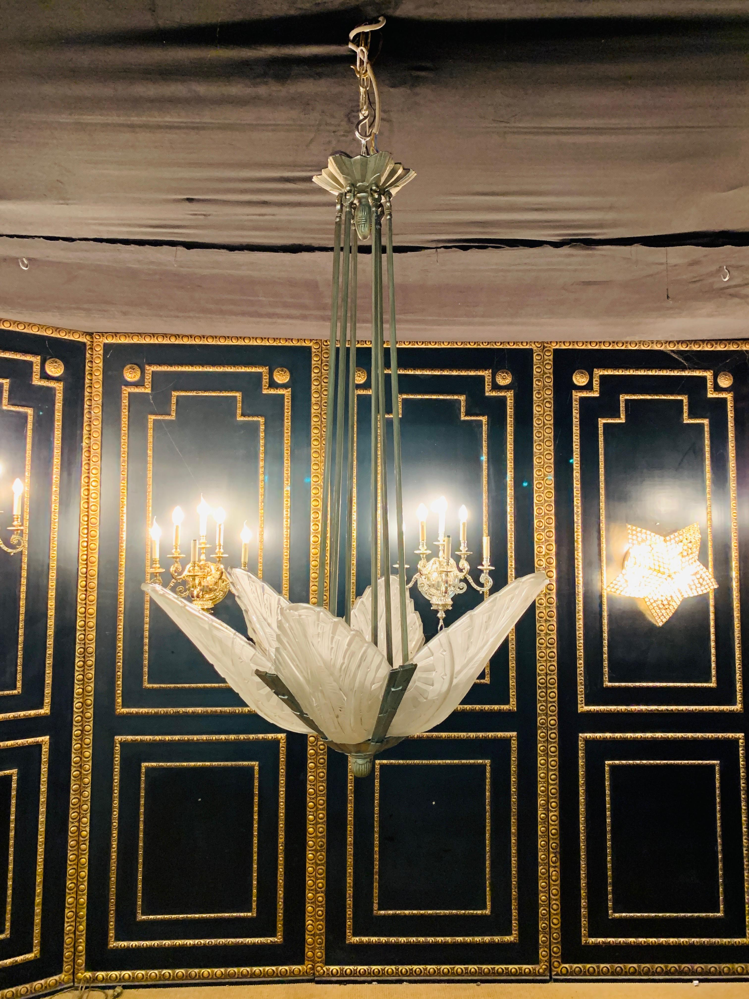 Elegant French Art Deco chandelier. With five clear frosted glass panels having geometric motif. Polished details on a silvered nickel frame with a streamline design.