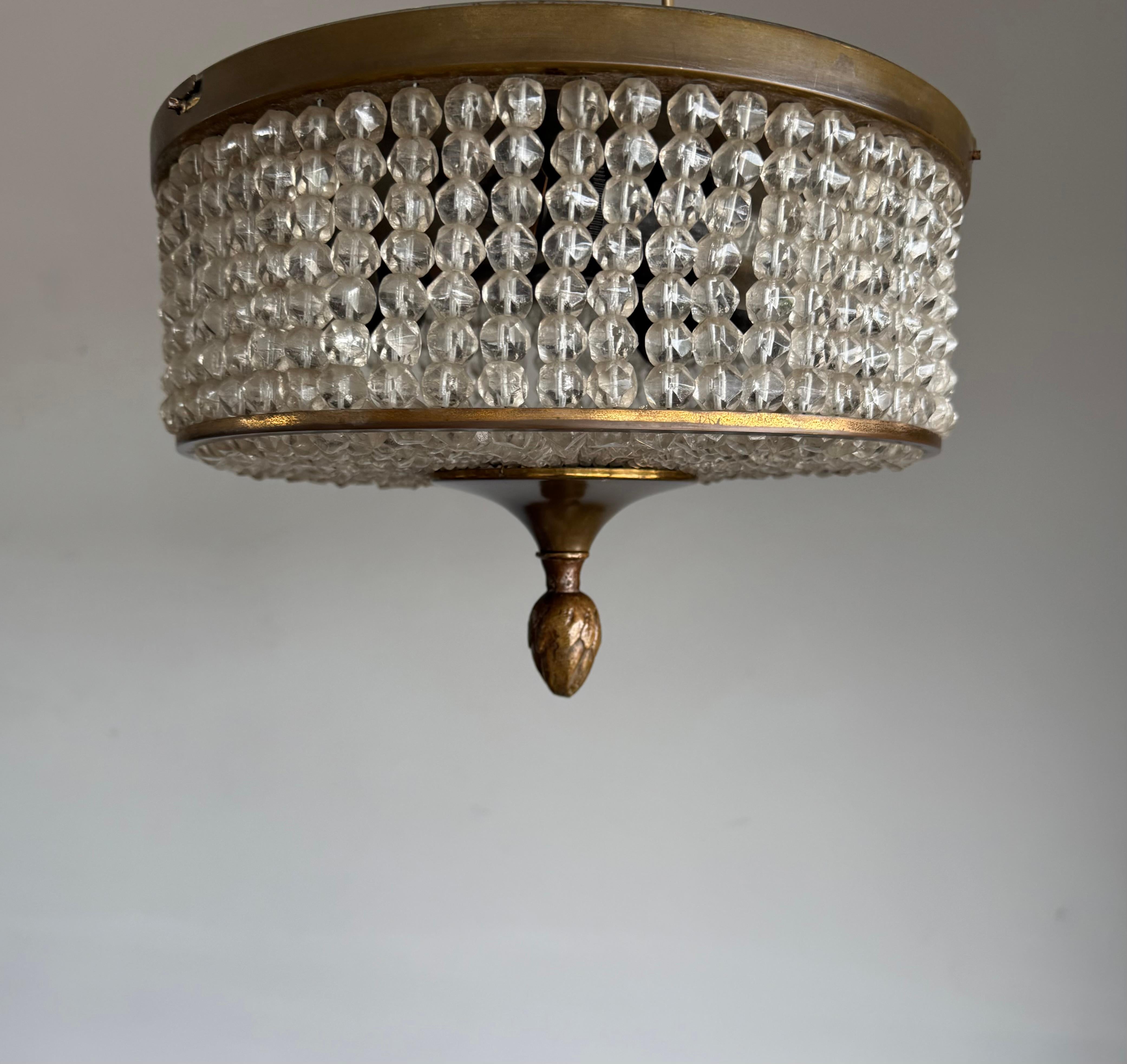 Infuse your space with timeless elegance through this exceptional French Art Deco flush mount ceiling light, dating from around 1940. A perfect marriage of refined geometry and artisanal craftsmanship, this fixture brings both ambient warmth and