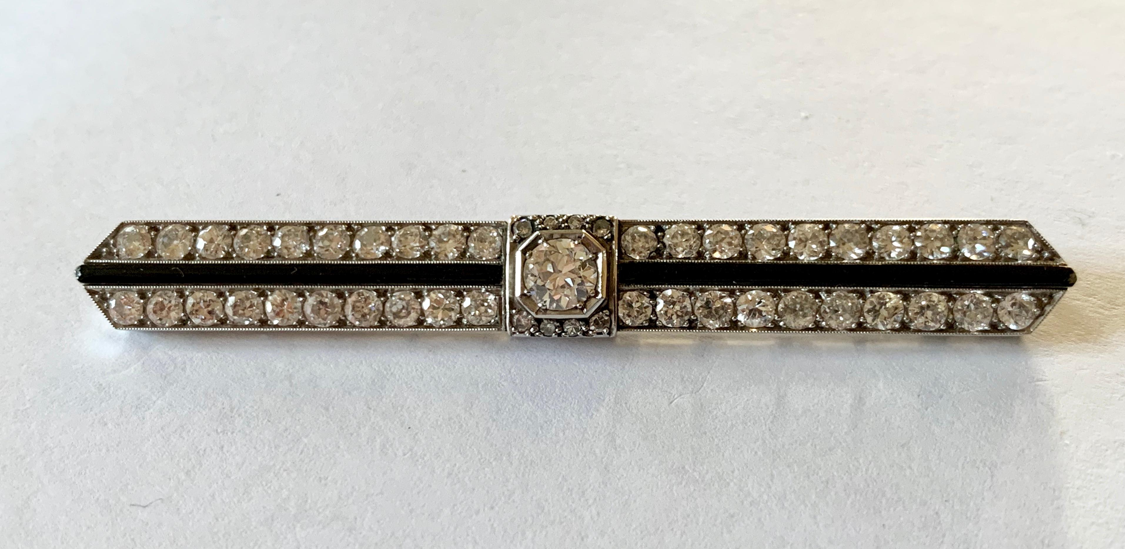  A superb and stylish  Art Deco diamond and Onyx bar pin brooch  featuring a center diamond weighting approximately 0.50 ct. Around the center diamond are approximately 2 ct of old cut diamonds and Onyx,  all set in platinum. A brooch from the early