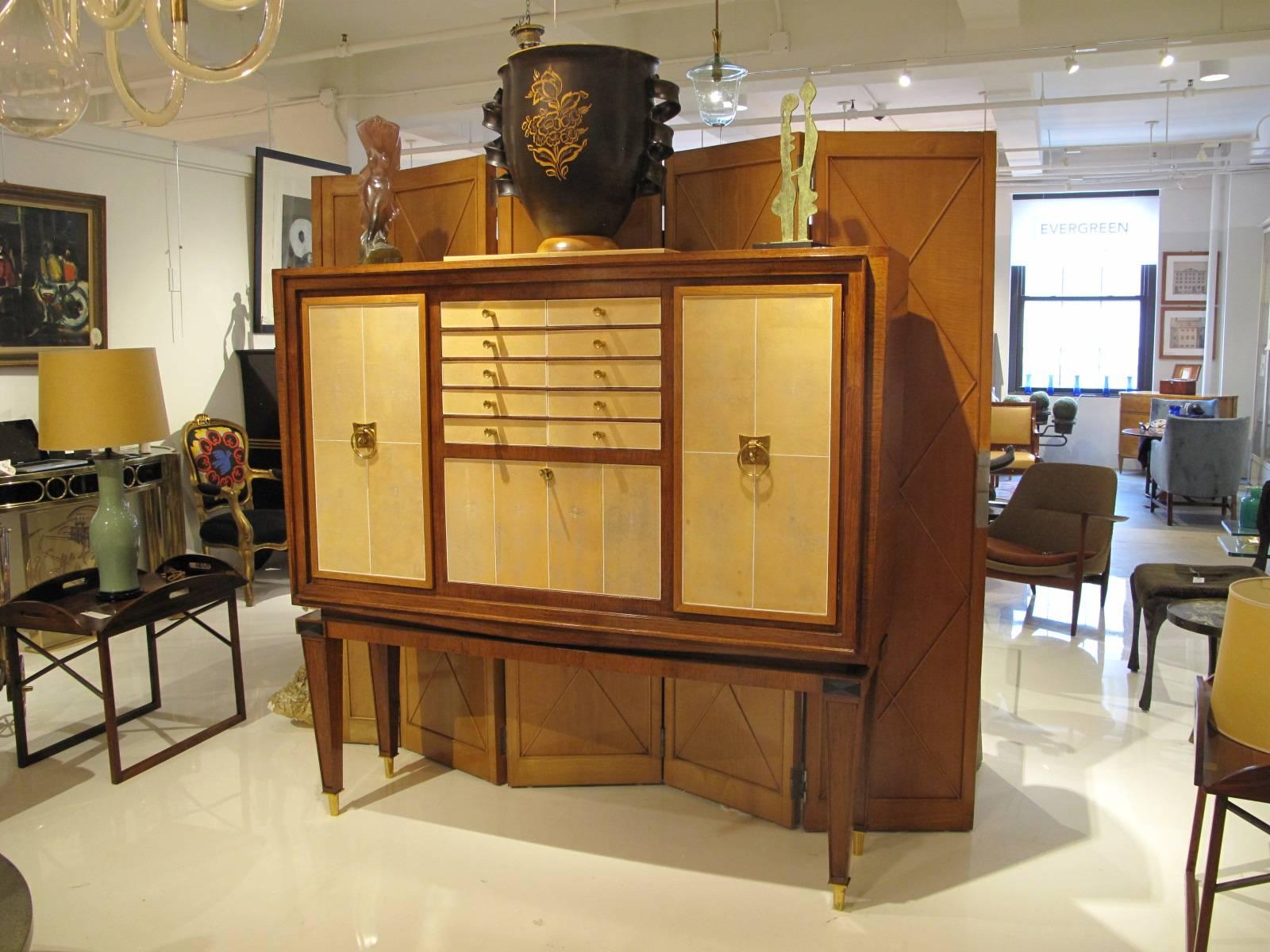 Elegant French Art Deco waknut and shagreen cabinet with black marble inlay and polished brass mounts, fitted with two cabinet doors, silverware drawers and drop front bar compartment.