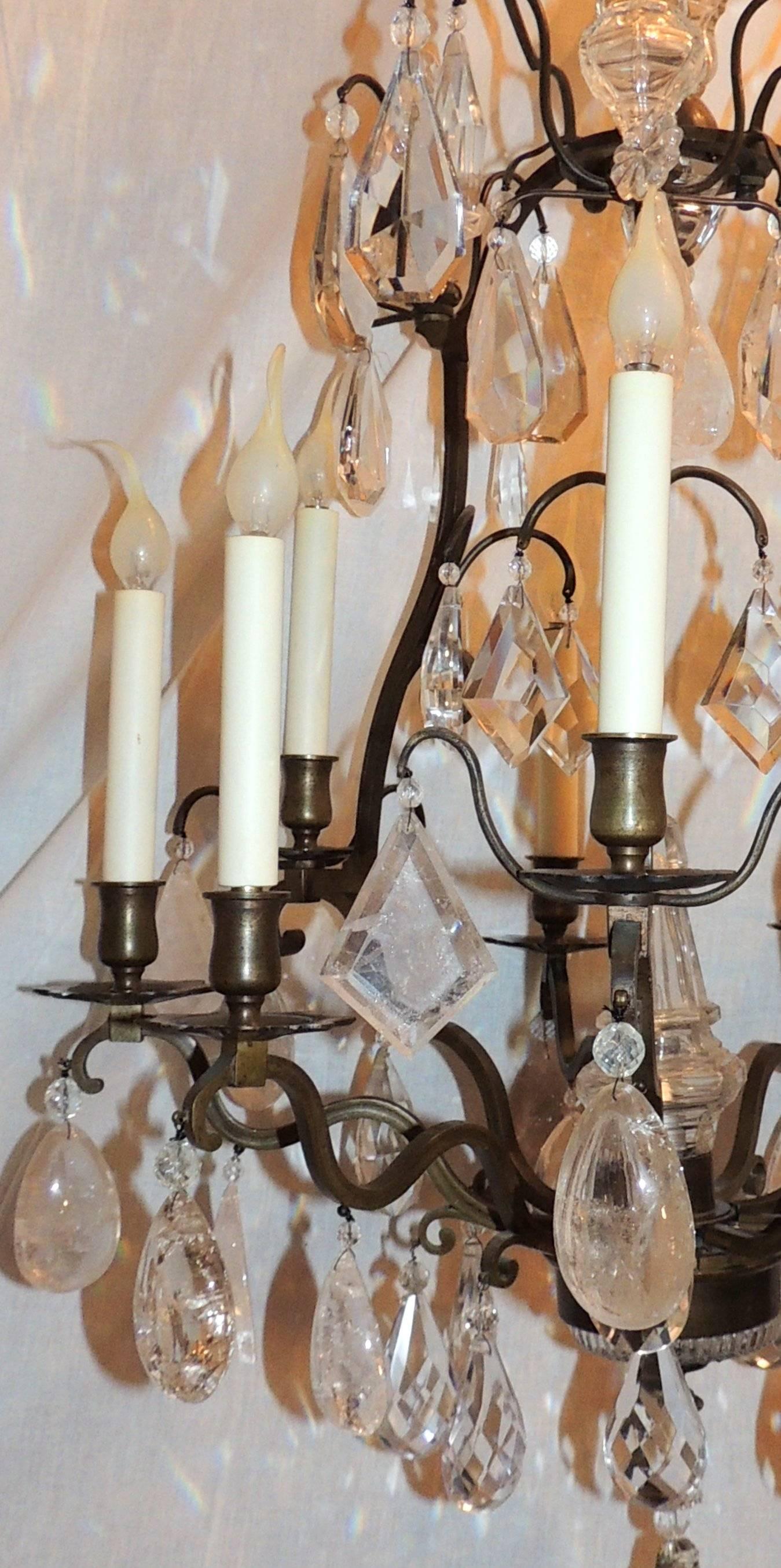 A wonderful French bronze ten-light rock crystal bird cage in the manner Baguès with patina this chandelier is centered by a beautiful crystal finial spires.

Measures: 41