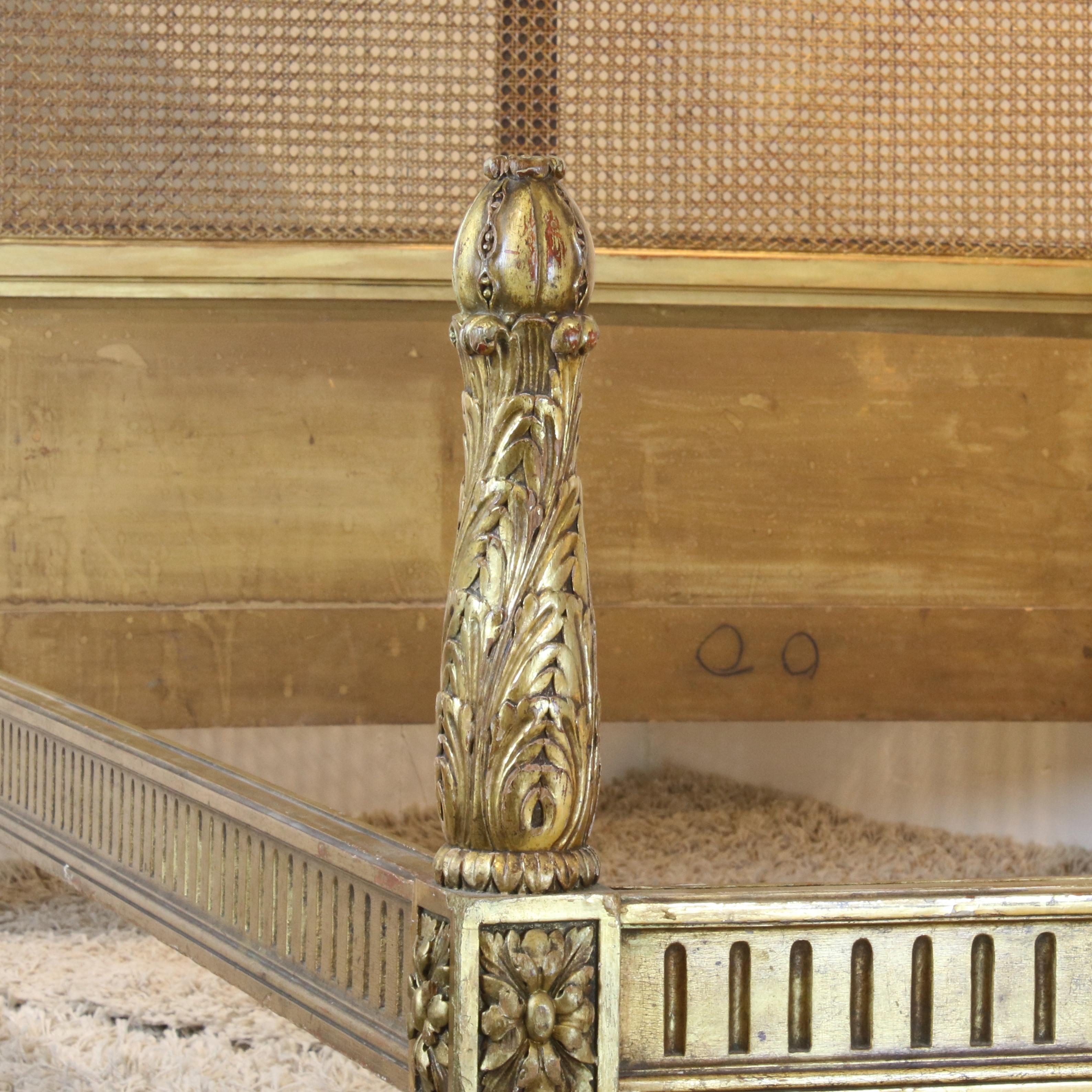 Elegant French can bedstead with gilded arched framework and torchon foot panel. On original side runners it accepts a 4ft wide base and mattress set with cut-out corners on the foot end, 6ft 3