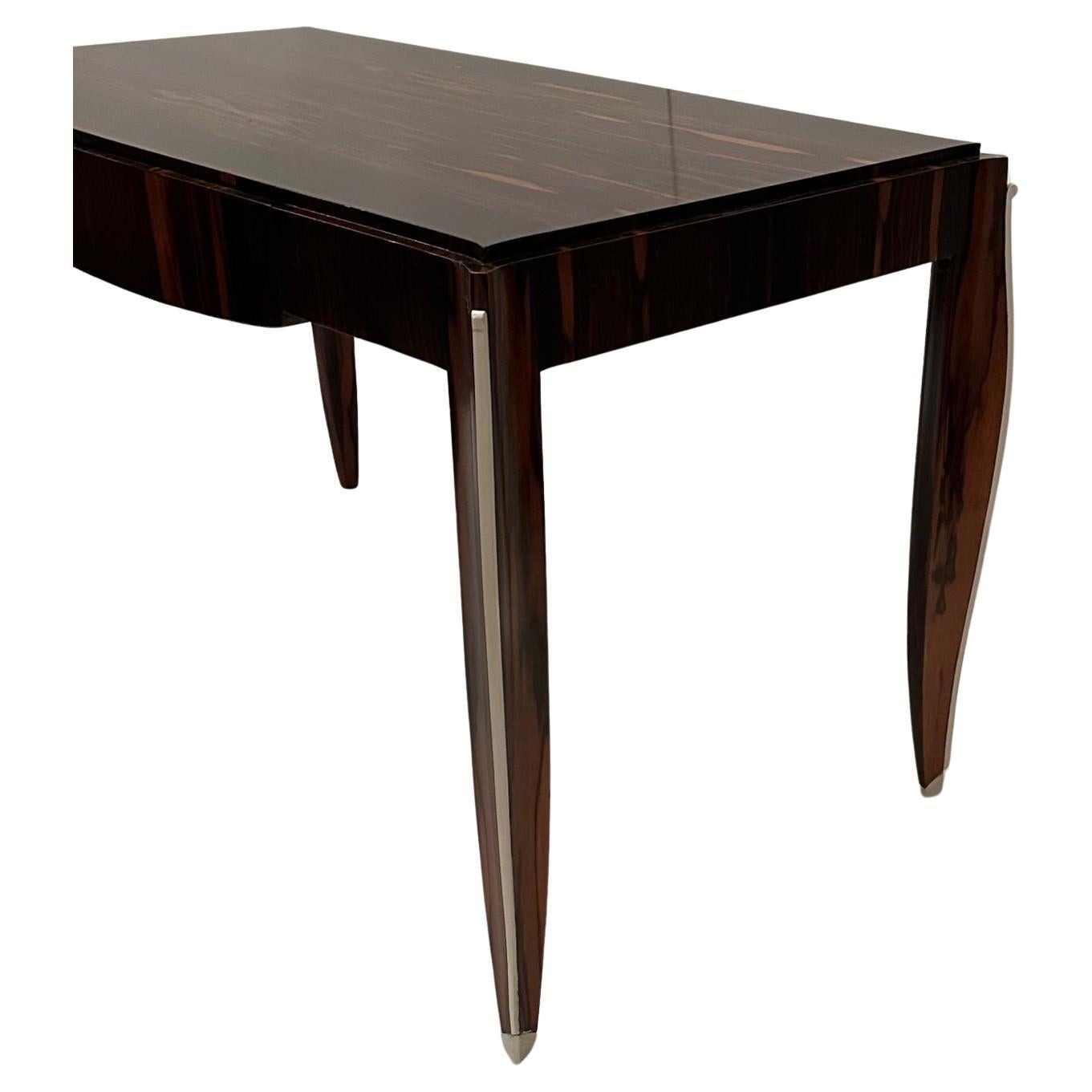 Sophisticated French Deco style rosewood veneer writing desk having gorgeous silhouette and unusual white lacquer trim on the legs and feet as well as single drawer.  Finished front and back.  23