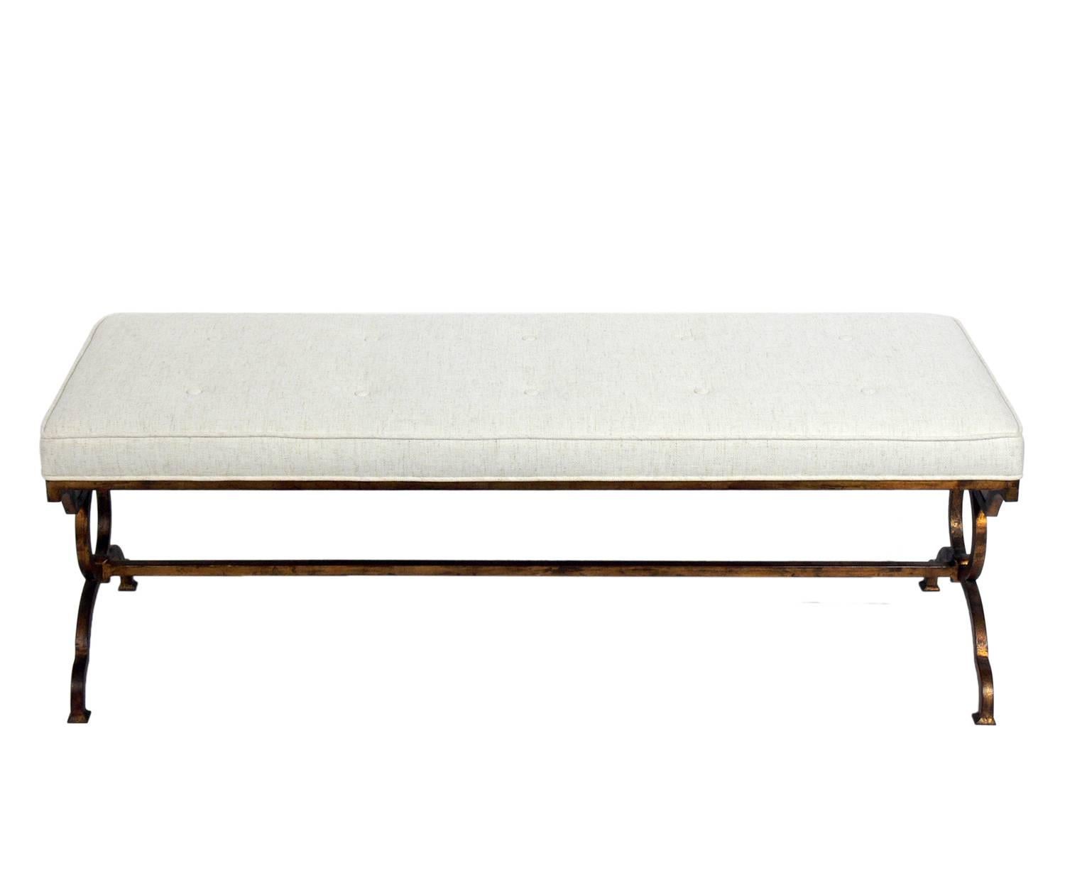 Elegant French gilt metal Bench, France, circa 1950s. It has been reupholstered in an ivory color herringbone fabric. The gilt metal frame retains it's warm original patina.