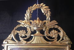 French Louis XVI Style Giltwood Mirror with Wreath Pediment, Early 20th Century