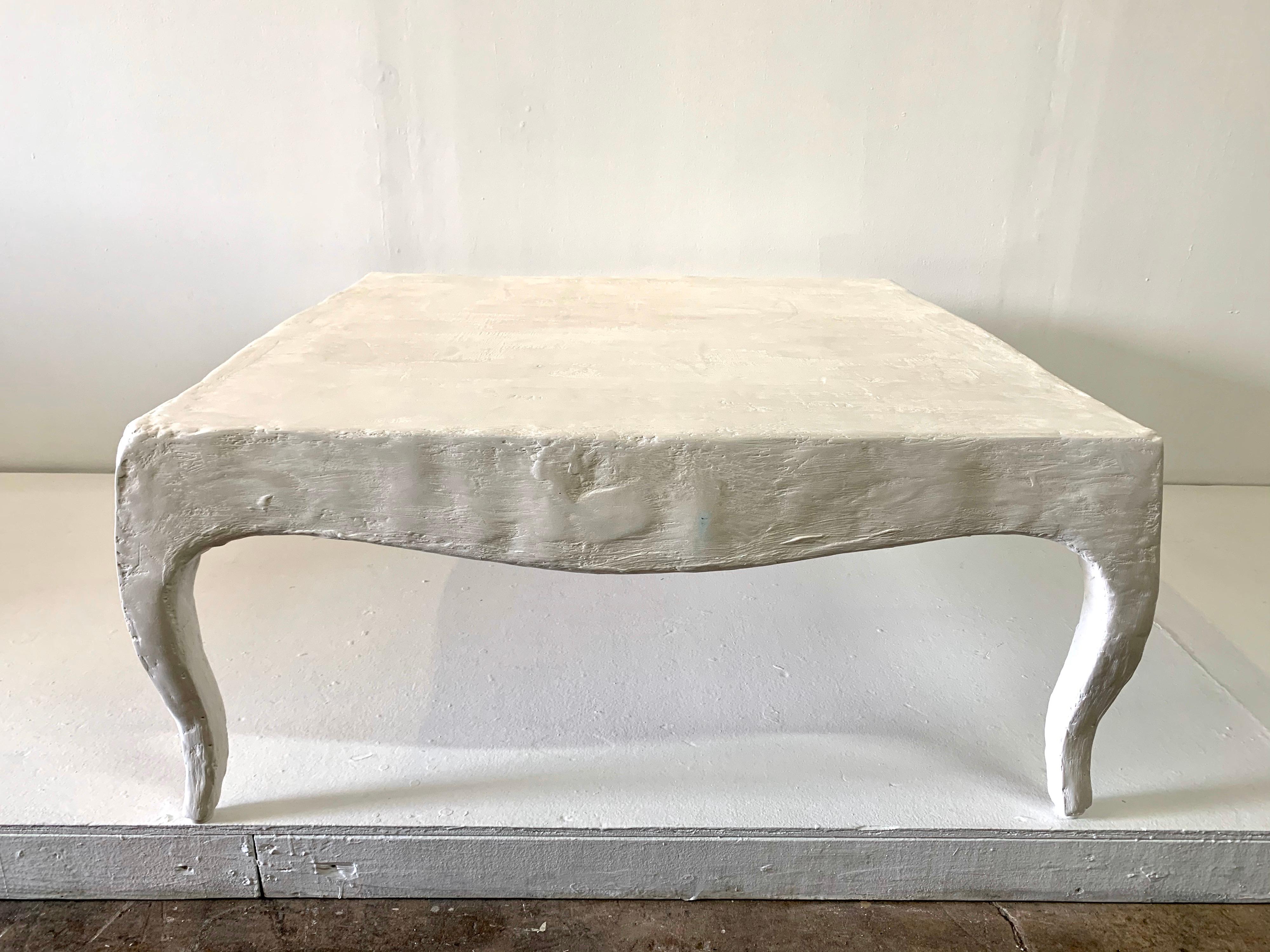 In the manner of Serge Roche, this very elegant cabriolet legged plaster cocktail table is a wonderful scale and beautiful finish.