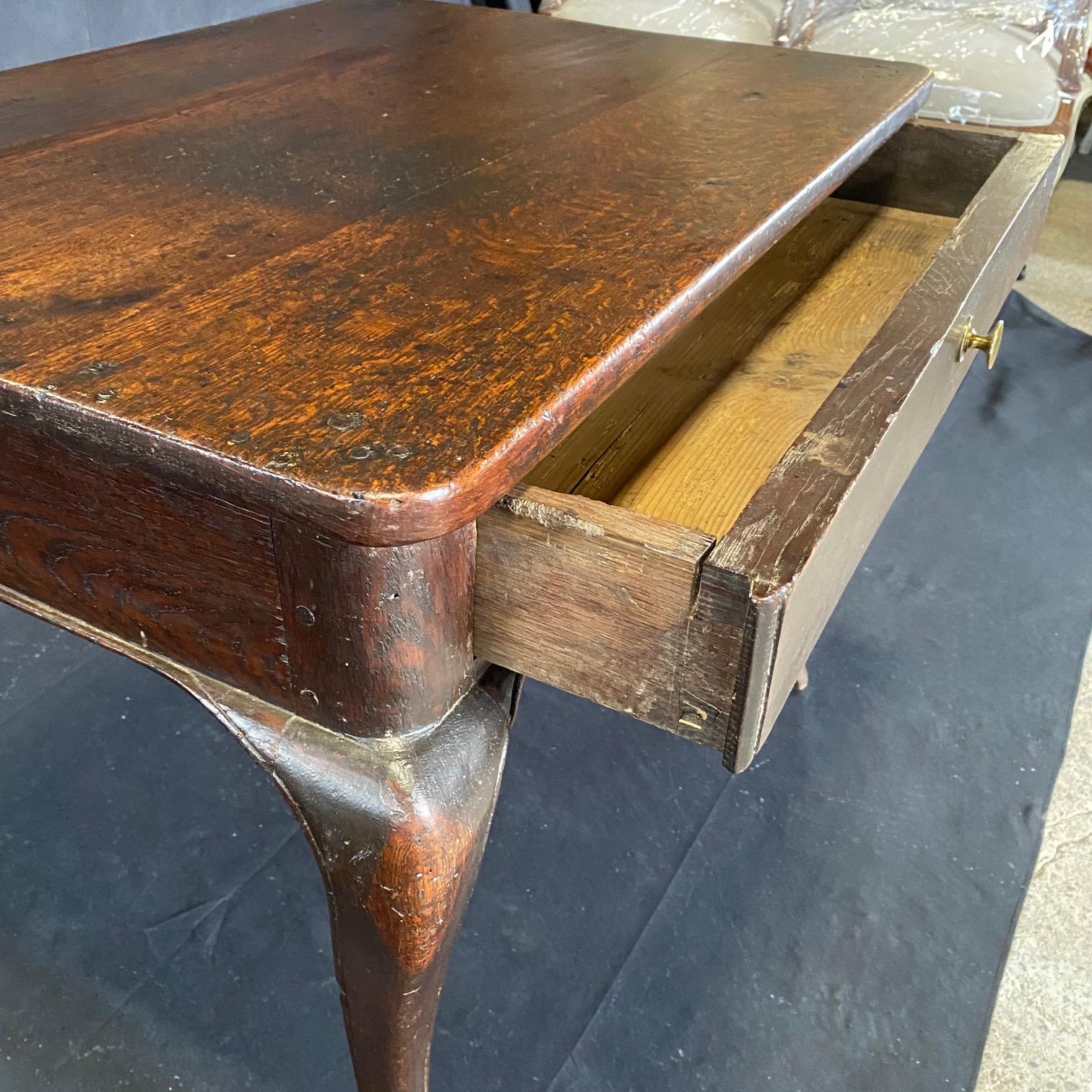 Elegant Louis XV side table or smaller scale desk bought in Avignon, France. Solid oak with one drawer and early peg joinery, this classy French side table rests upon four lovely hooved feet. #6002

H skirt 24”.
 