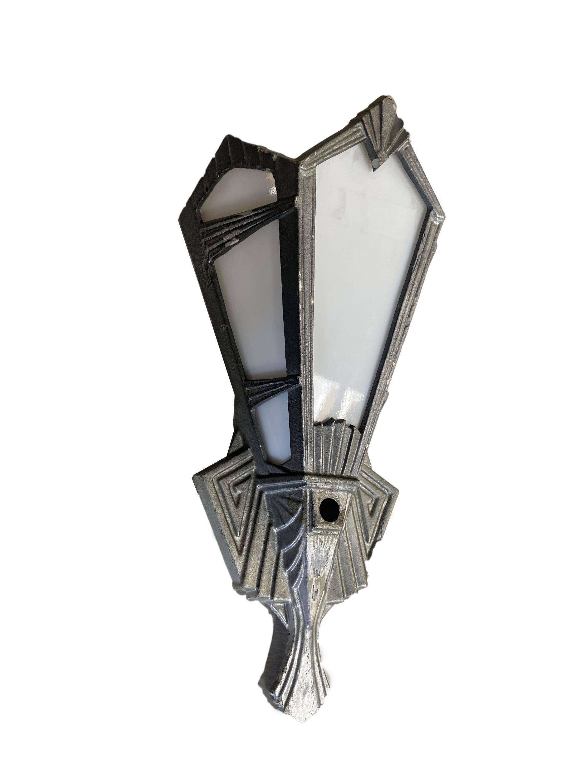 Vintage 1920s geometric Art Deco aluminum wall sconces with milk plane glass work.

Available-5.