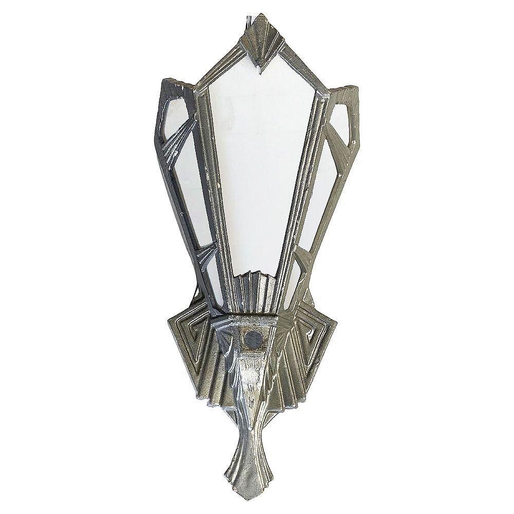 Original 1920s Art Deco aluminum wall sconces epitomize the era's geometric flair. Adorned with milk plane glass, their design reflects the treads in the movie theaters of classic Hollywood. The combination of sleek aluminum and elegant glasswork