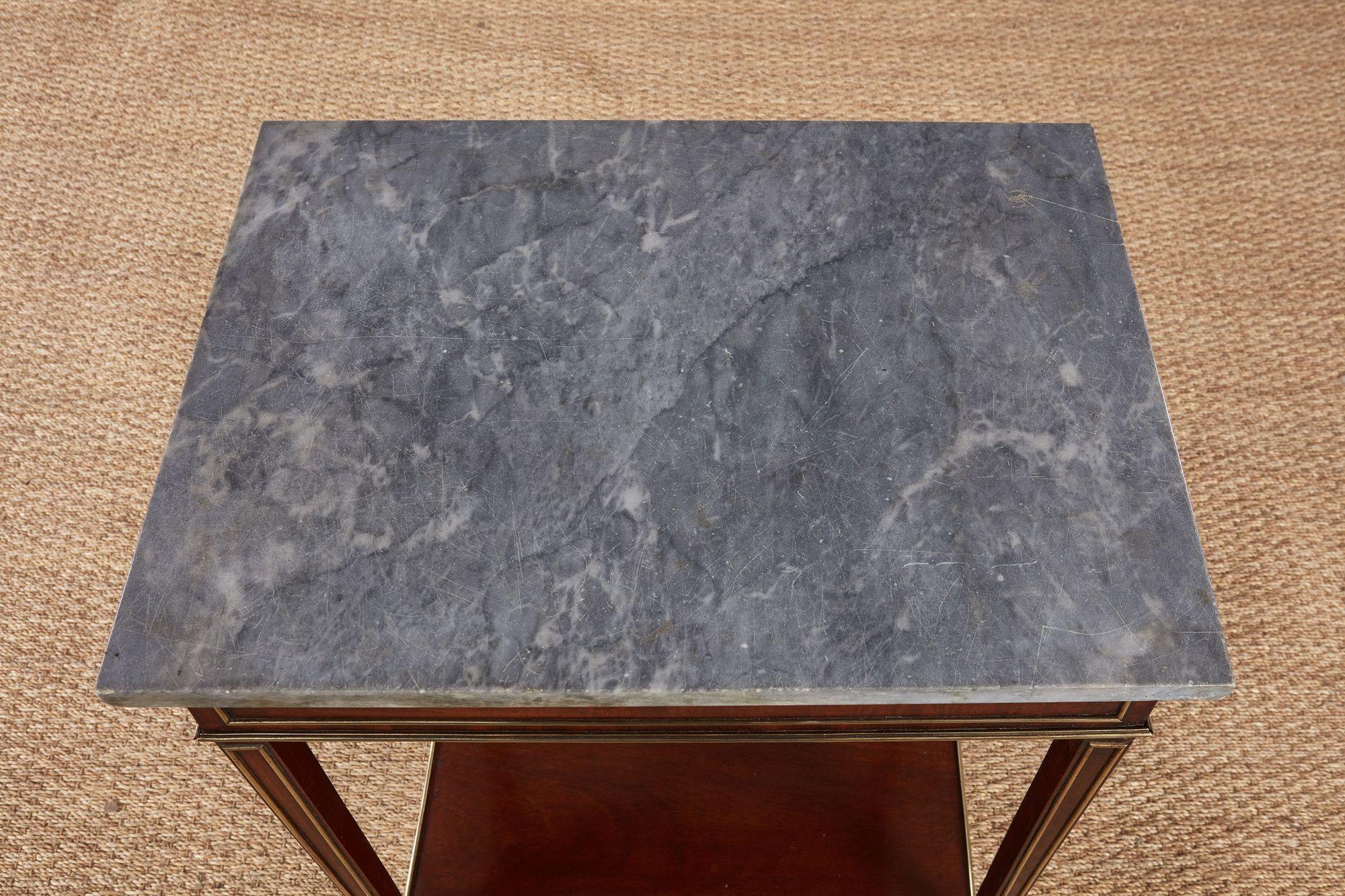 Fine George IV mahogany and brass trimmed marble top side table in the French taste, having original grey marble top over rich mahogany base, the legs and apron trimmed with brass quarter round molding, standing on splayed 