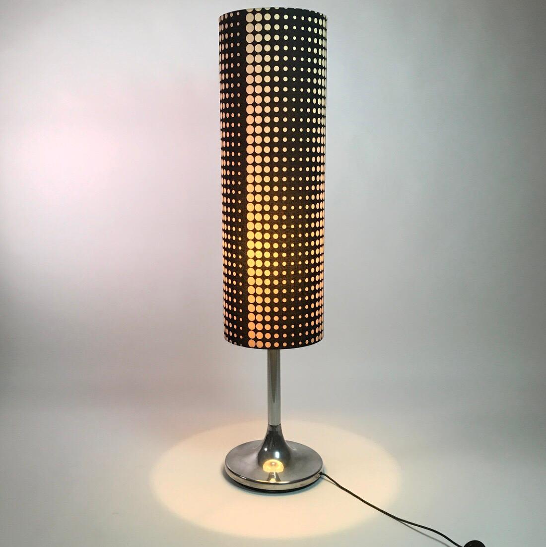 Rare tall Space Age floor lamp by Kaiser Leuchten from the 1970s.

Functionalism and beautiful design are the keywords for this stunning floor lamp.

The awesome pop- or opart black doted shade, chrome tulip shaped base and tall and narrow body