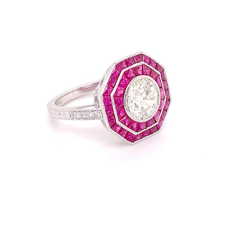Gorgeous platinum GIA certified 1.46 carat center diamond featuring stunning rubies weighing 1.63 carat and 0.11 carat small diamond ring. 


