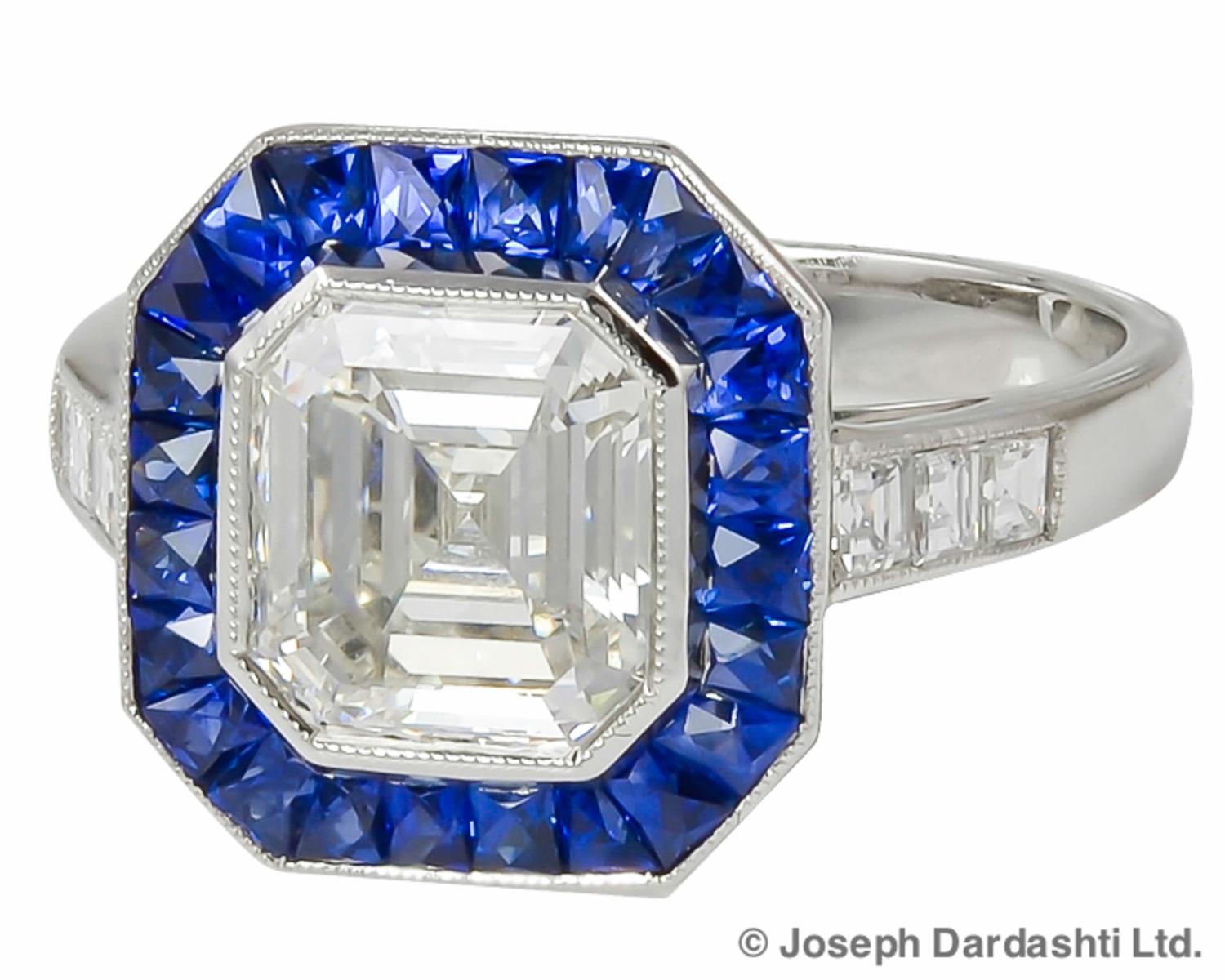 Sophia D GIA certified platinum ring features a 3.37 carat center square cut diamond with a color and clarity of K-VVS1 surrounded with blue sapphire weighing 1.20 carats and diamonds weighing 0.28 carats ring. Ring is available for