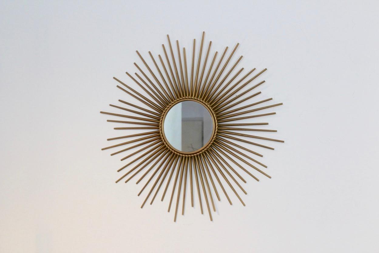 Elegant and beautiful gilded metal framed Sunburst Mirror made in the 1960s in France by Chaty Vallauris. Very elegant and in very good condition. With mirrored glass center in molded frame with rope motif trim. Excellent!