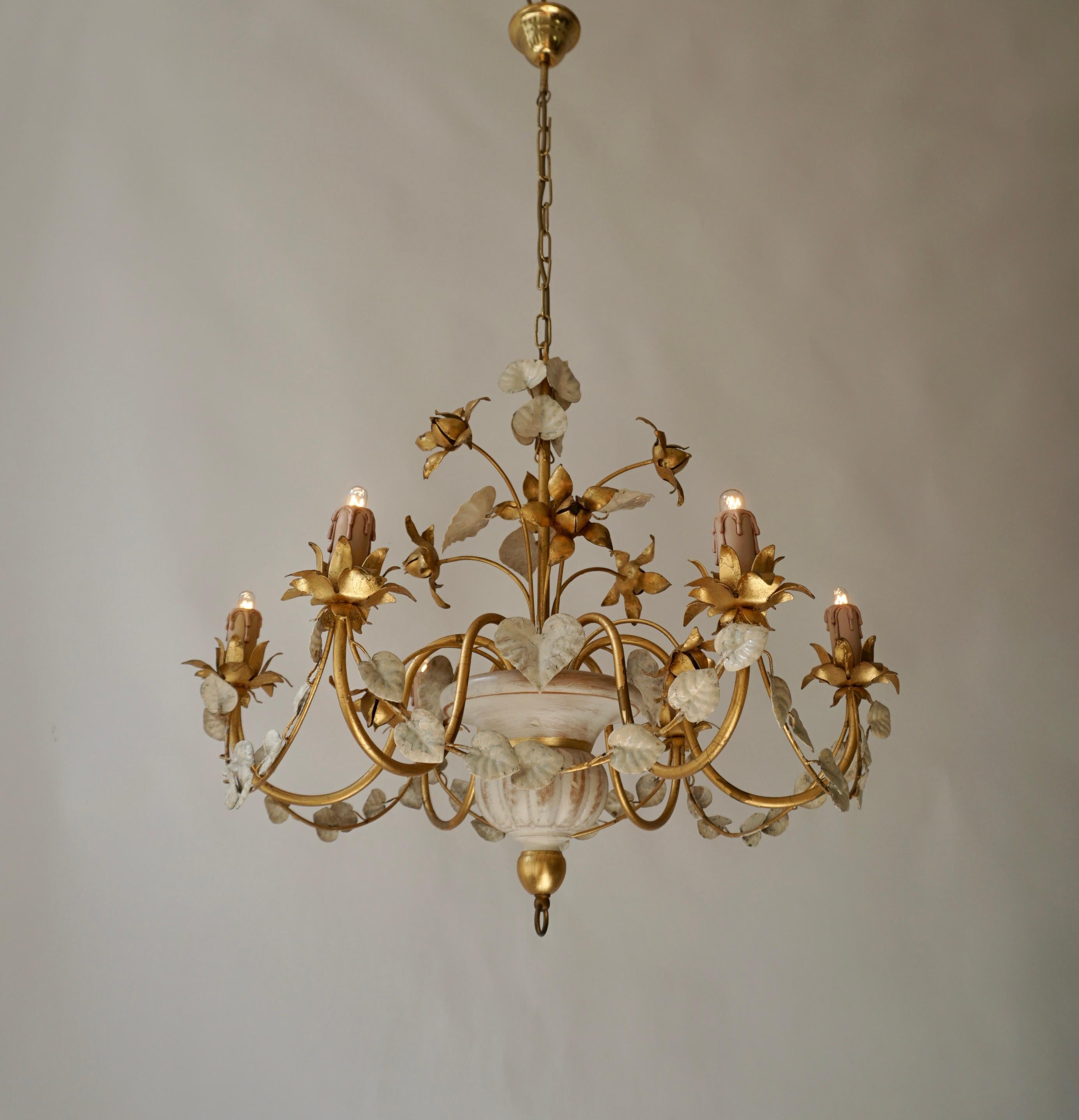 Beautiful golden beige chandelier with gold colored flowers and white leaves.

Diameter 27.1
