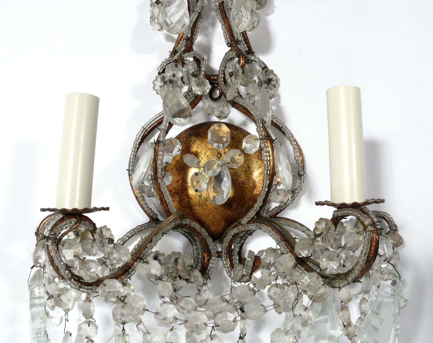 Elegant gilt metal and crystal sconces, Italy, circa 1950s. They have been rewired and are ready to use.