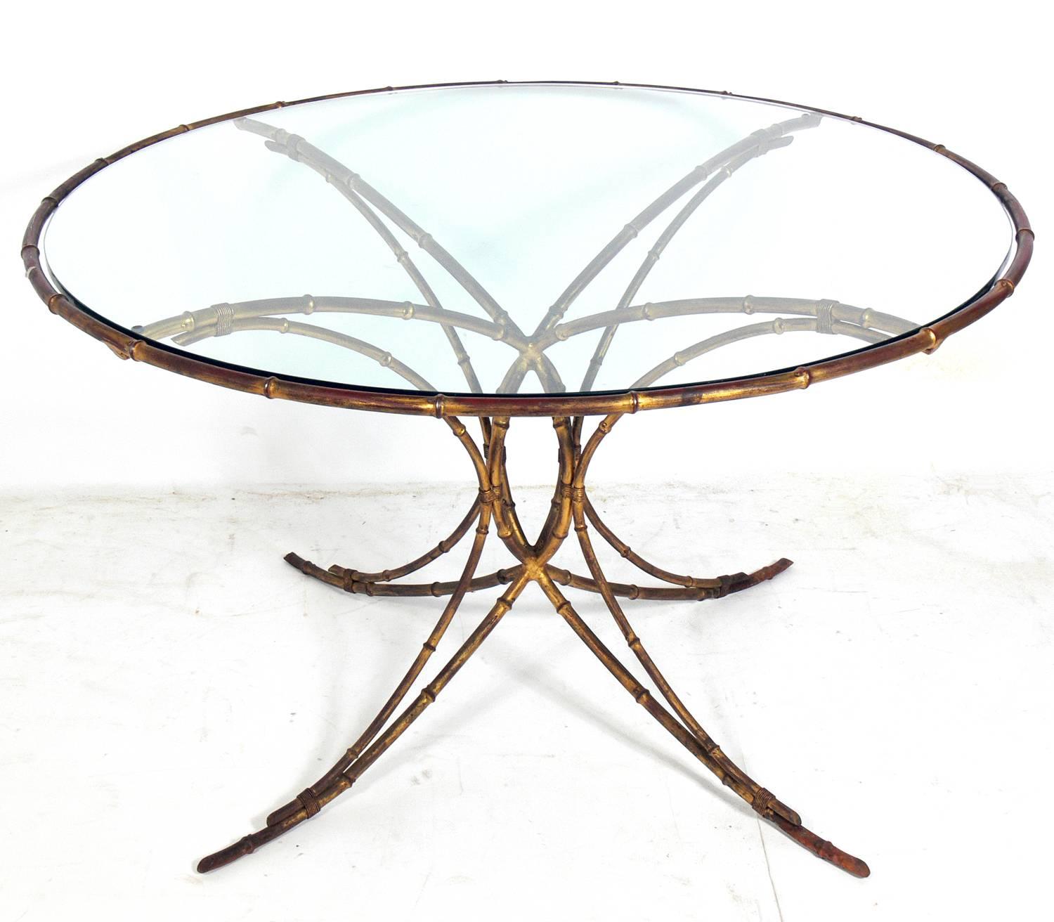 Elegant gilt metal faux bamboo dining set, probably Italian, circa 1950s. The set consists of the dining table, two armchairs and two side chairs. The dining table measures: 28.5