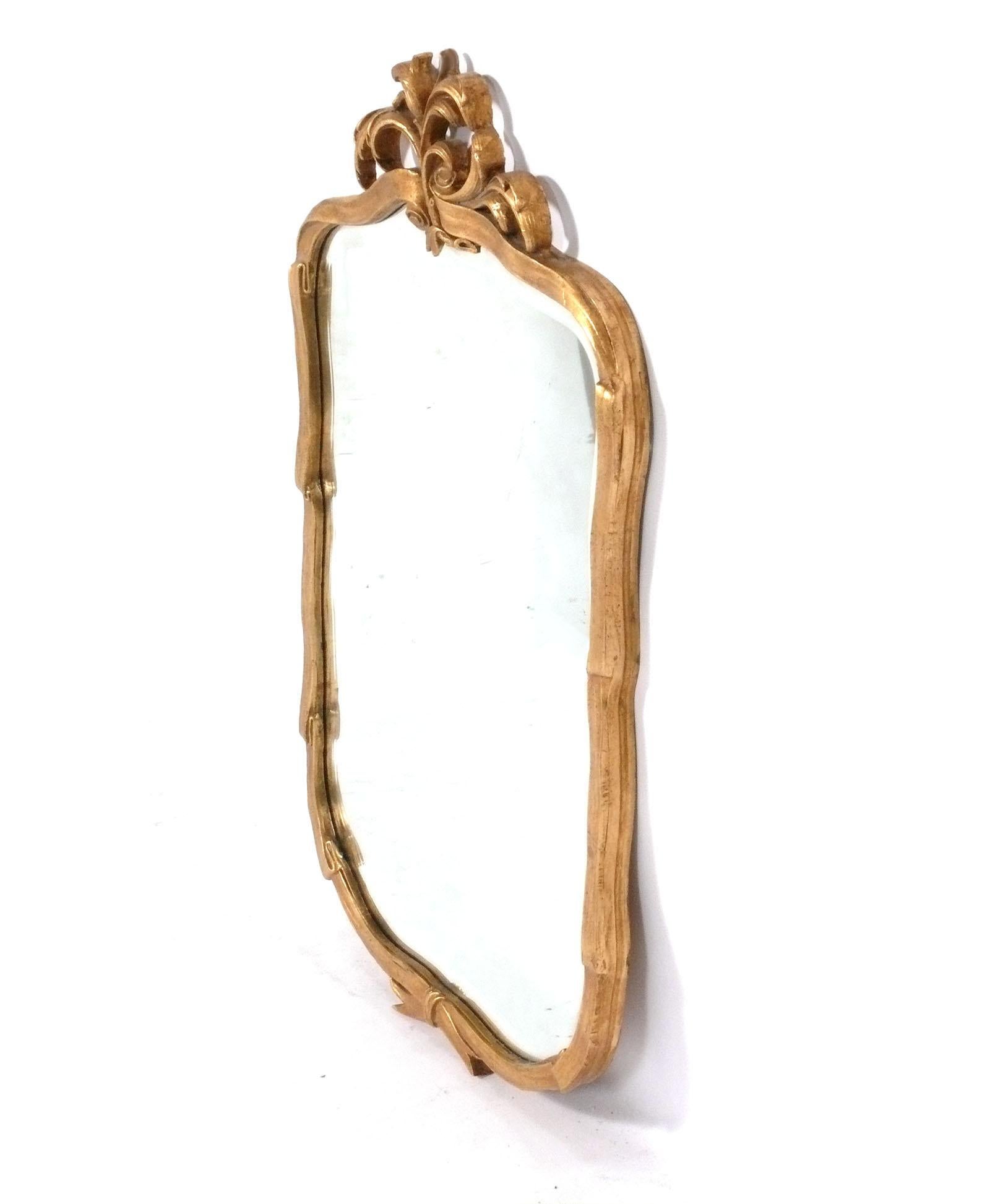 Elegant Gilt Ribbon Form Mirror, probably American, circa 1950s. It was recently removed from The Carlyle Hotel in NYC. It measures 41.5