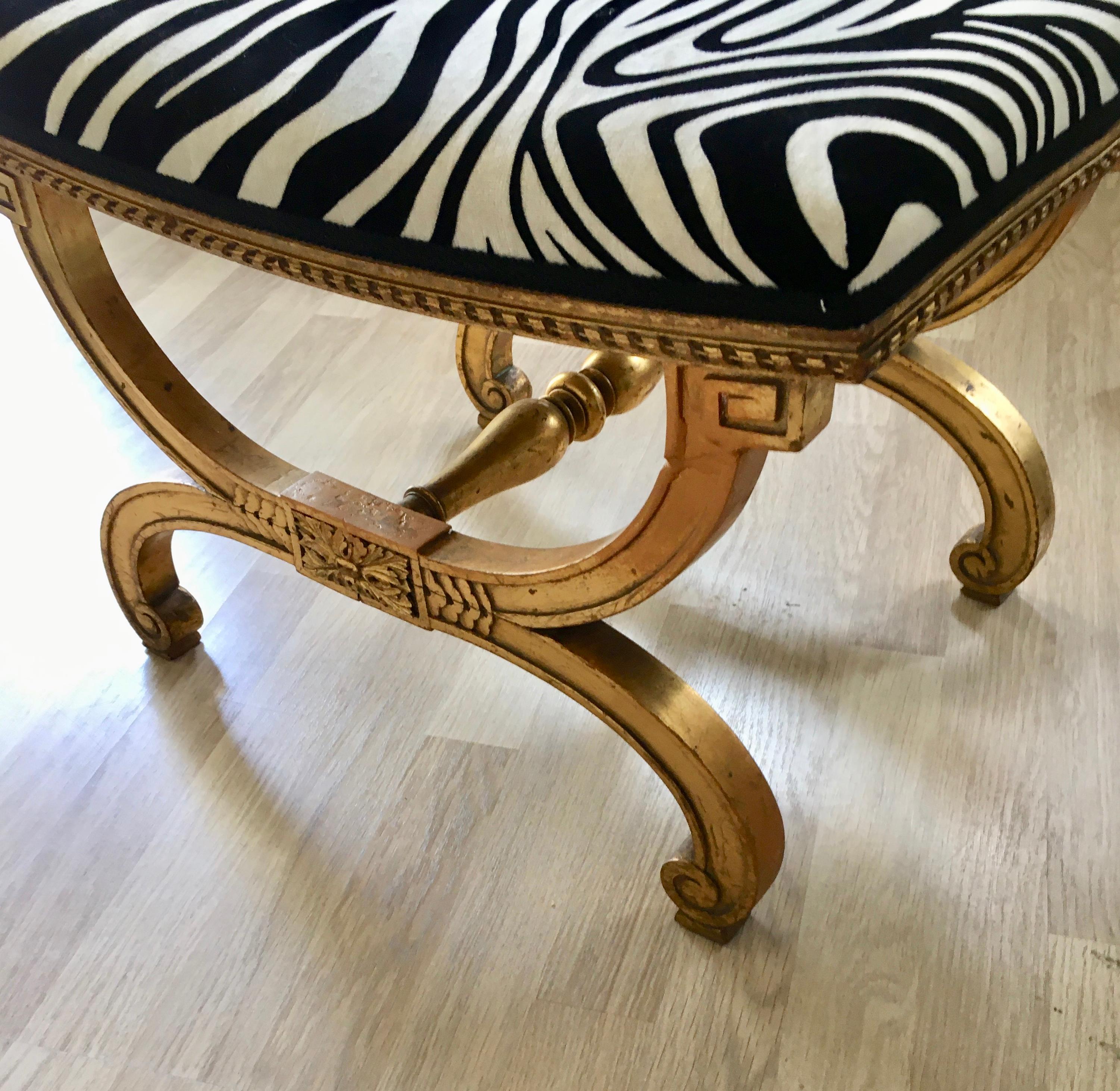 Hand carved ottoman with a fine gilding and reupholstered with a zebra fabric (Lelièvre-France).
France, 1920.
