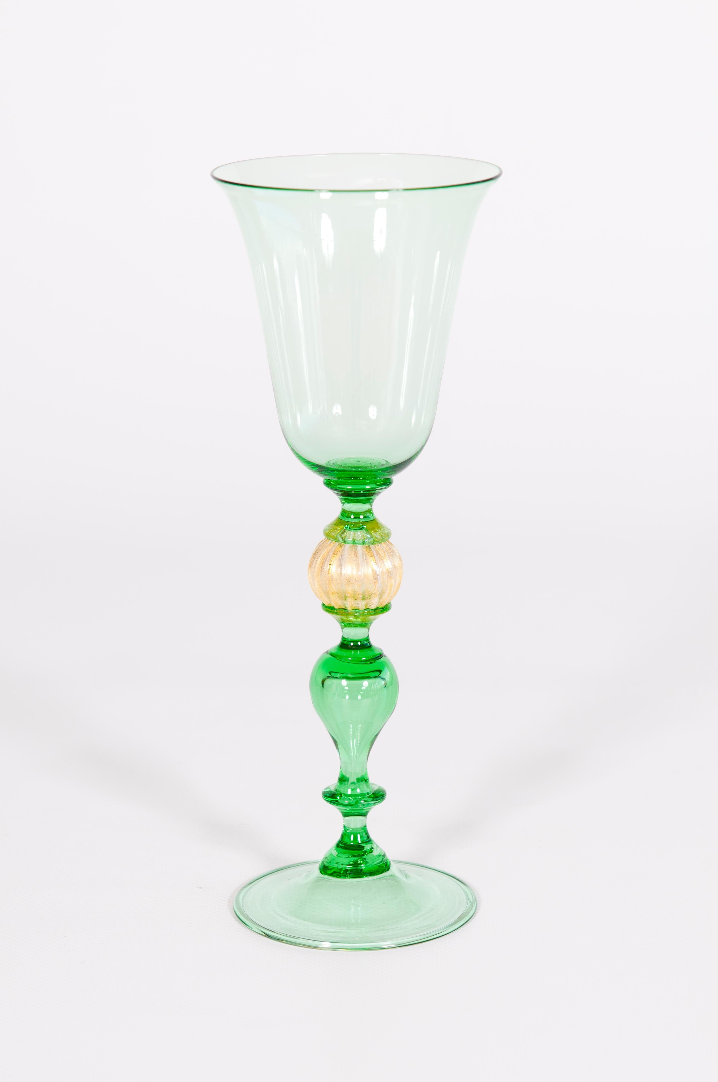 Elegant Glass in Green with Gold Leaf color  in blown Murano Glass 1990s Italy.
This is a fine piece of the Italian art of Murano blown glass. It was entirely handmade by local glass artists, as is clearly visible by the precision of all the