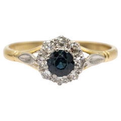 Elegant gold ring with sapphire and diamonds.