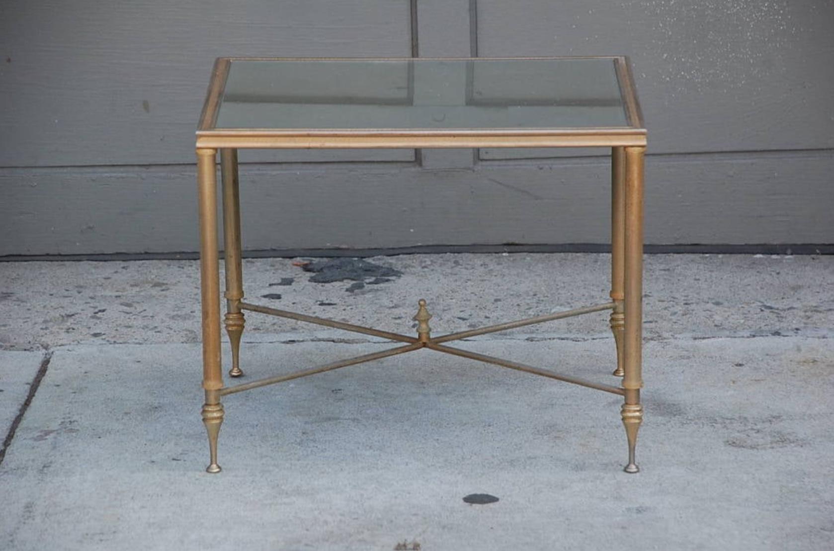 Elegant gold side table with antique mirrored glass.