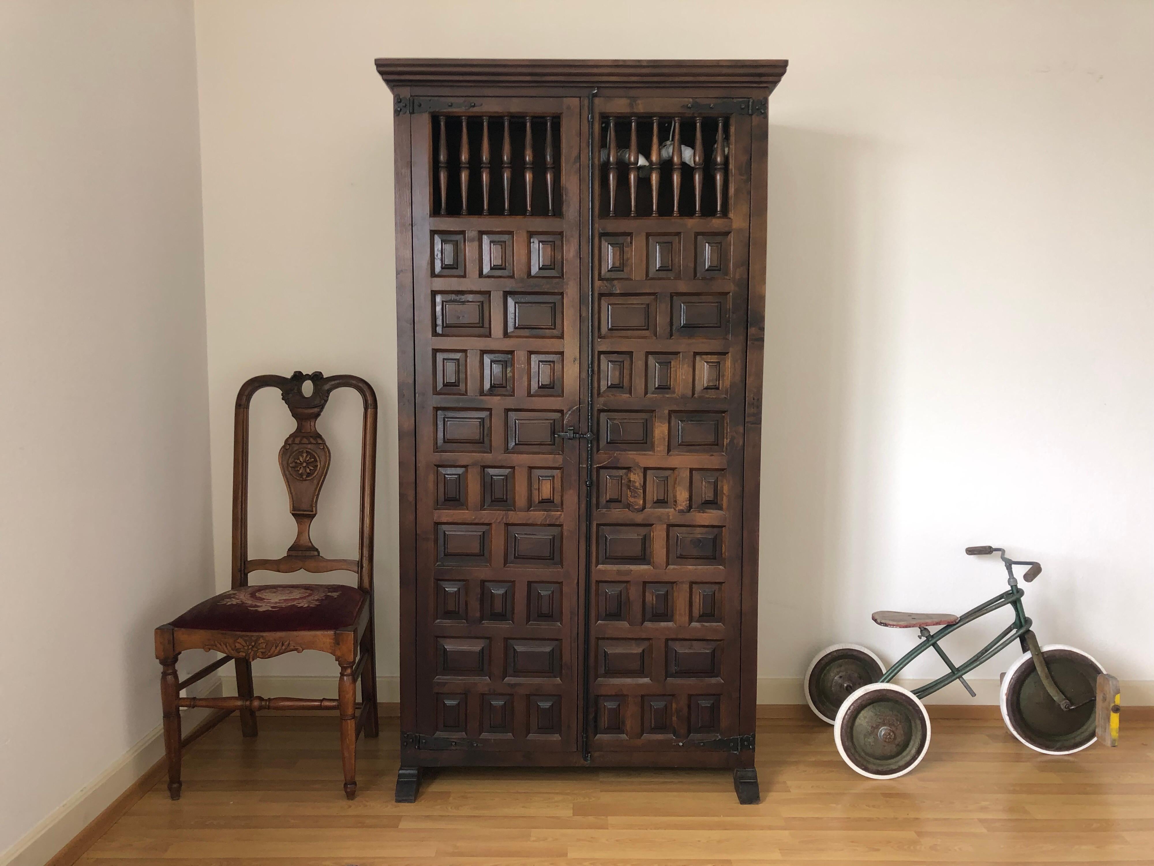 Elegant single dark wood wardrobe with one low shelve, two open doors and one hanger (as shown with the white hangers). Beautiful front wooden details and metal antique style connections.
Gothic Asian style armoire, easy to transport.
 
