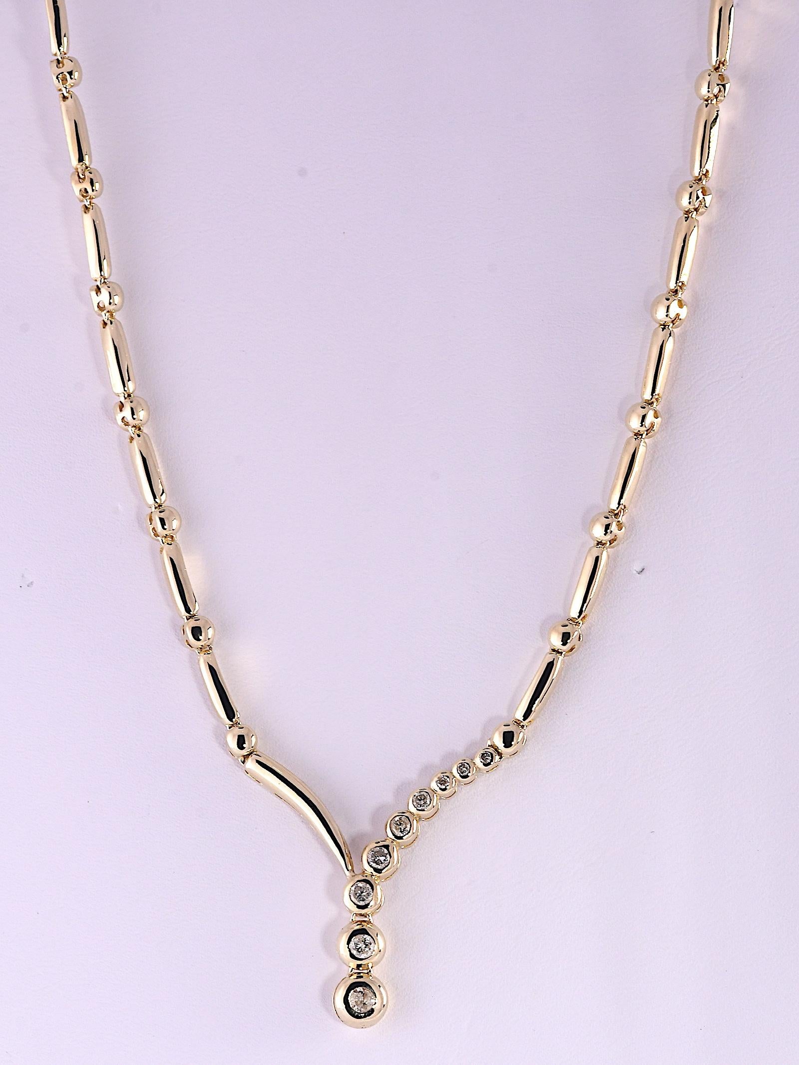 Beautiful high polished alternating bar and bead links with nine graduating bezel set diamonds at the 