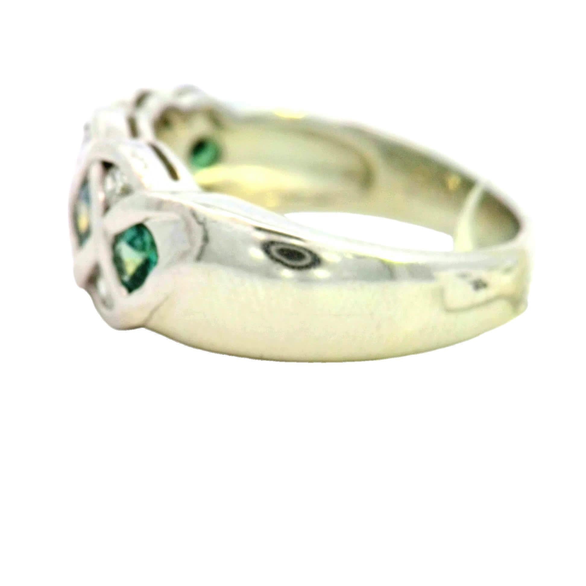 Discover the exquisite beauty of this elegant ring, featuring a stunning design that intertwines vibrant green gemstones with sparkling white diamonds. Crafted from high-quality white gold, this piece is perfect for adding a touch of sophistication