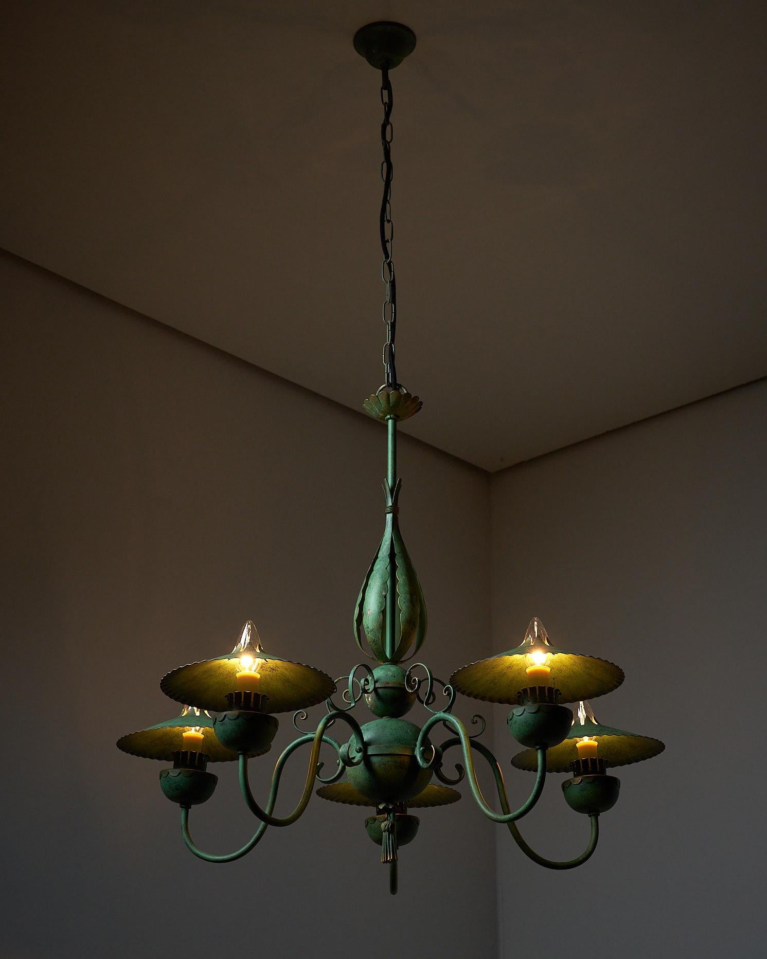 A striking piece with a faux green brass finish. Its captivating forms and aesthetics are enhanced by charming little shades that complement each lightbulb perfectly. Completely rewired for optimal functionality, we currently have 2 pieces in stock.