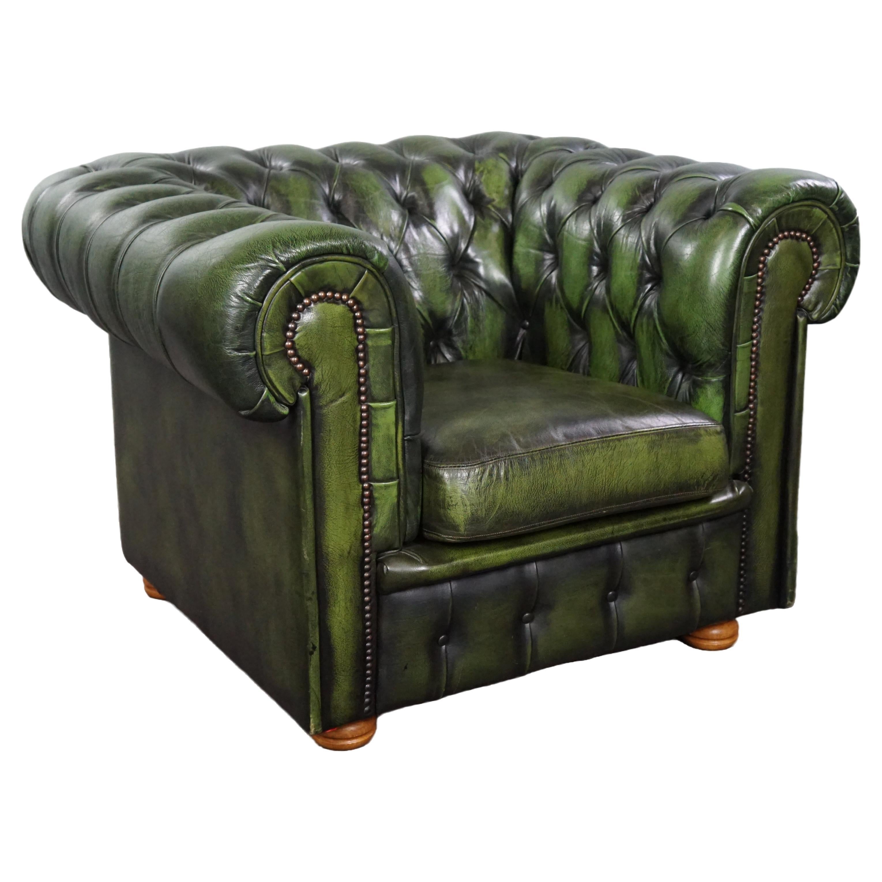 Charming green Chesterfield button seat armchair made of cowhide
