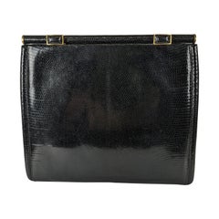 Elegante bolso de mano de lagarto negro de Gucci