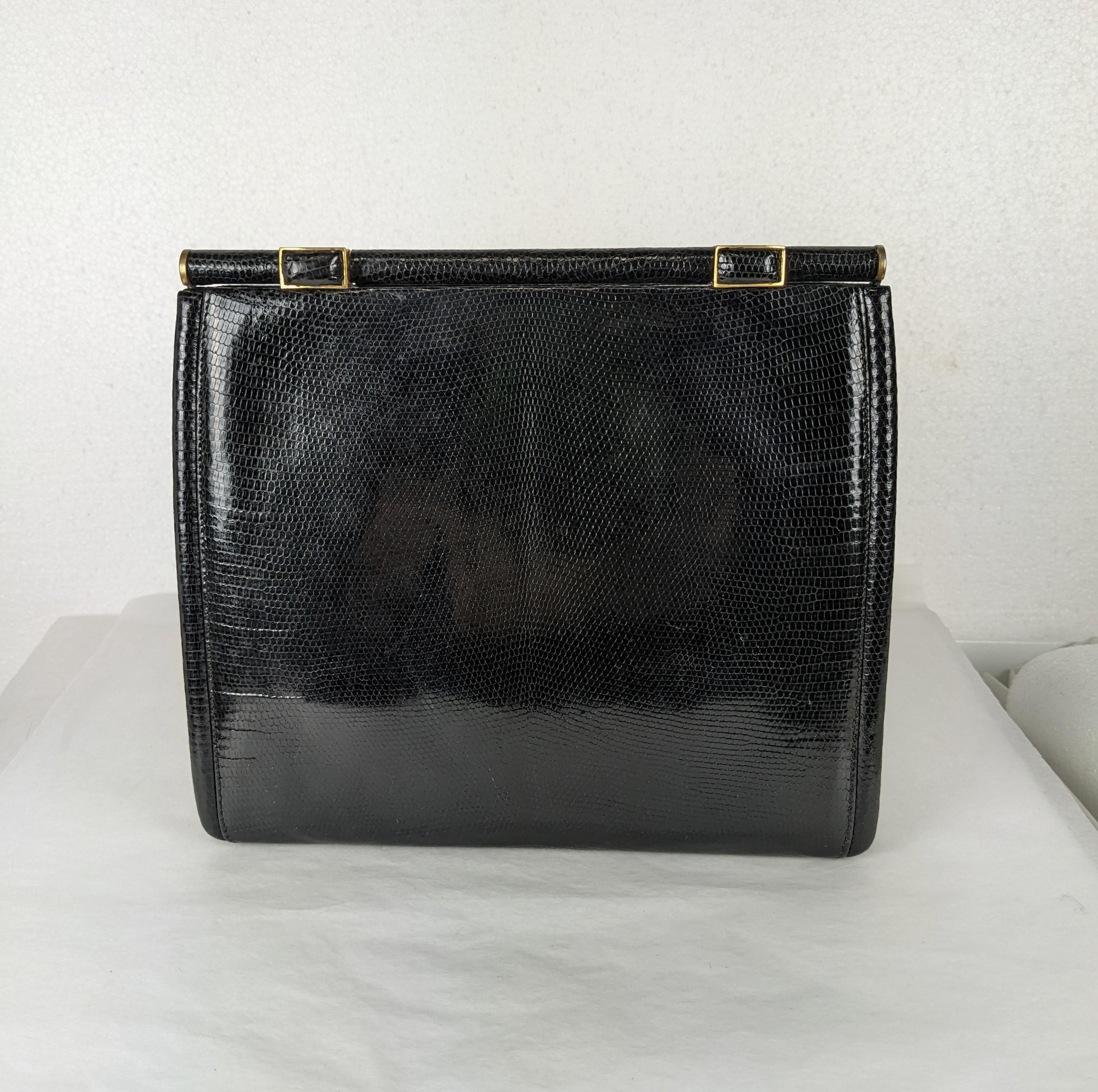 Elegant Gucci Black Lizard Clutch from the 1980's. Elegant square shape with 2 skin covered tabs which you press to unlock frame. Expands at base to hold more. Suede lining. 1980's Italy. 8.5