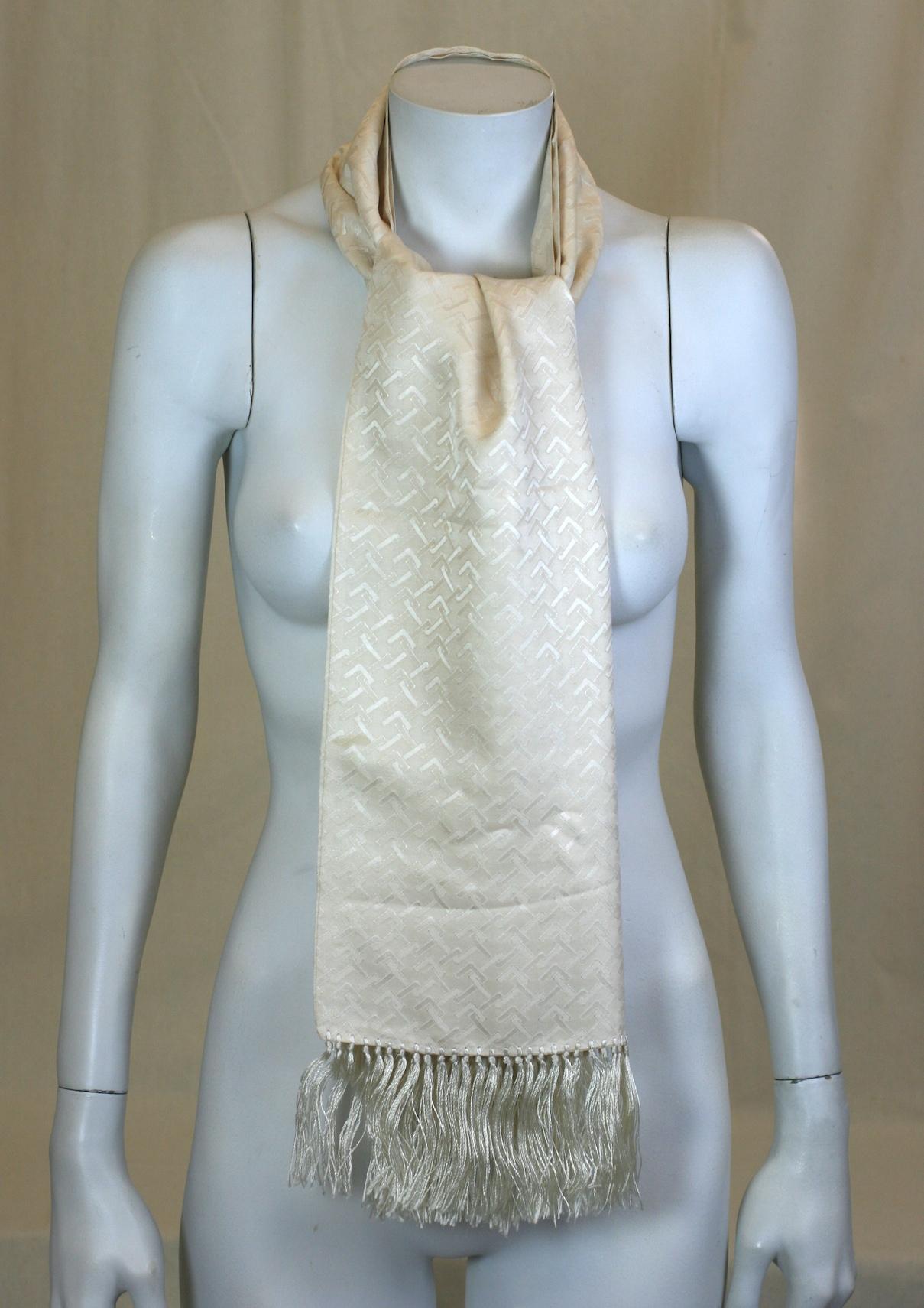 Elegant unisex Gucci Ivory Silk Jacquard Logo Scarf from the 1970's. Amazing Gucci's 70's Jet Set vibe with hand made silk fringe. Tuxedo ready.
Conjoined 