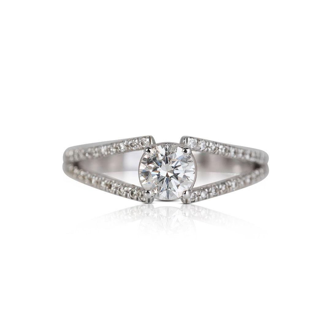 At the heart of this ring is a dazzling solitaire diamond, meticulously chosen for its exceptional quality and brilliance. The solitaire setting highlights the innate beauty of the diamond, allowing it to take center stage and shine with