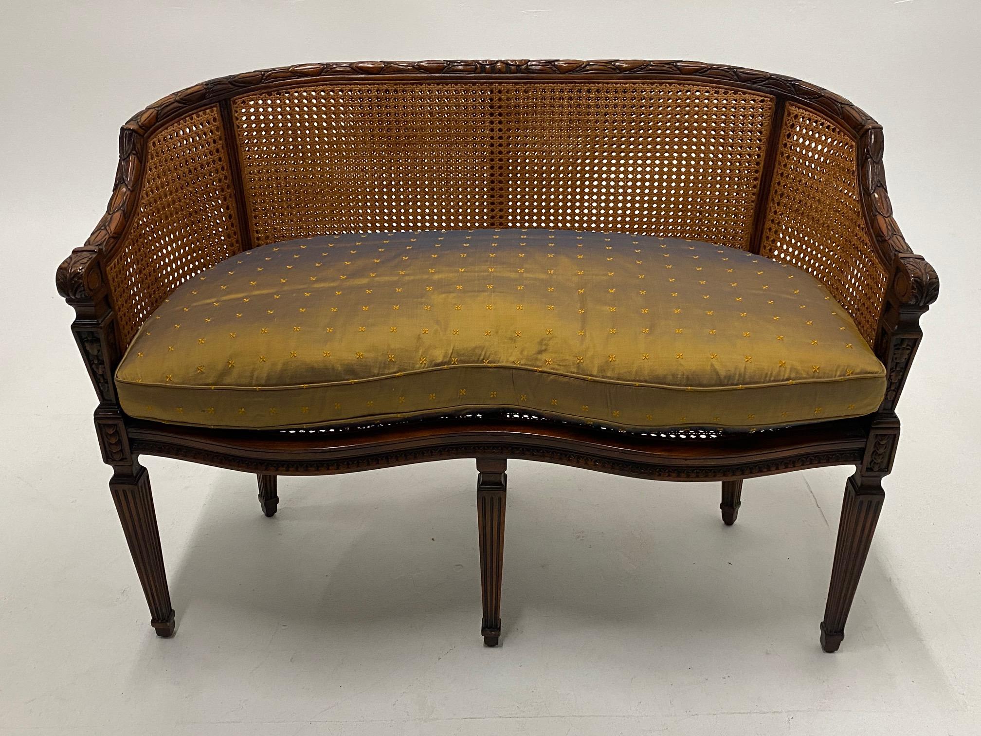 Lovely curved French carved mahogany and caned loveseat having plush silk seat cushion filled with down.
Seat height without custom cushion 17