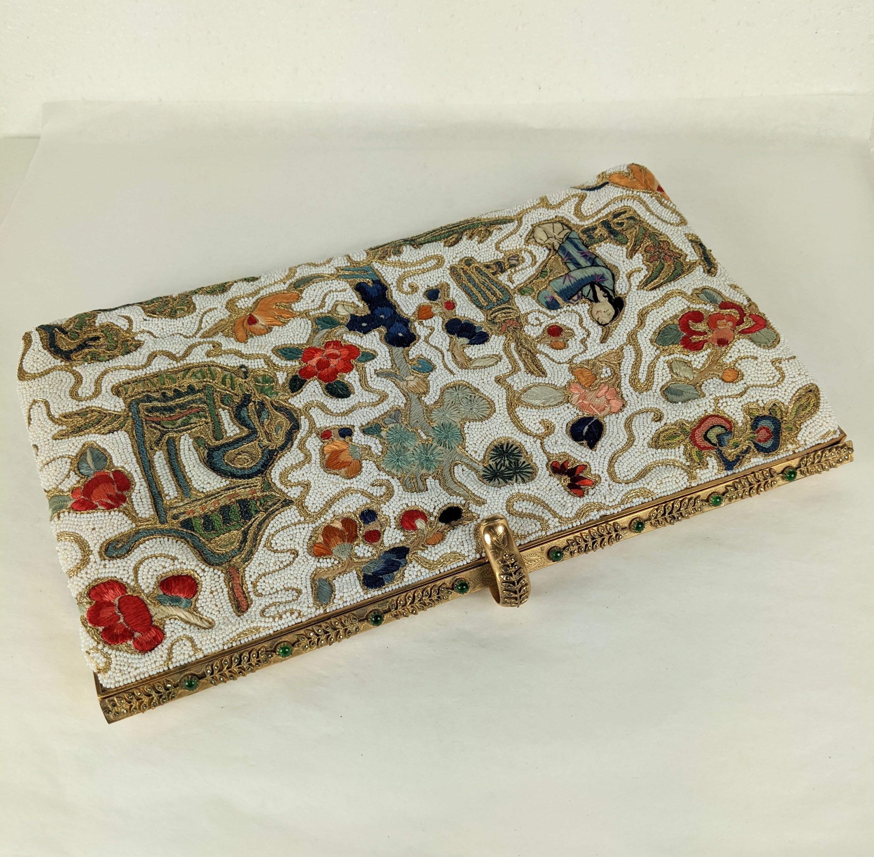 Chic Hand Embroidered and Beaded Chinoiserie Clutch made in France from antique Chinese textile from the early 20th Century. Wonderful quality with marcasite set fern motifs with Green glass cabochons. Lined in silk satin with gold lame cording with