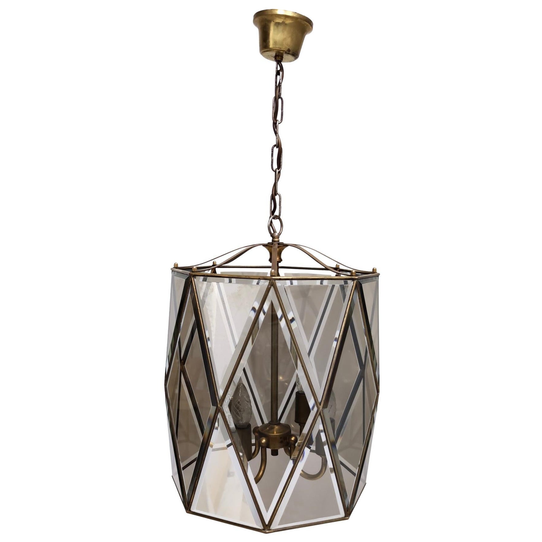 Made in Italy, 1950s. 
This refined pendant lantern is handmade and entirely made by skilled Italian artisans.
It features 24 beveled glass pieces, which have been assembled with a pinpoint precision with a brass frame.
It is a vintage piece,