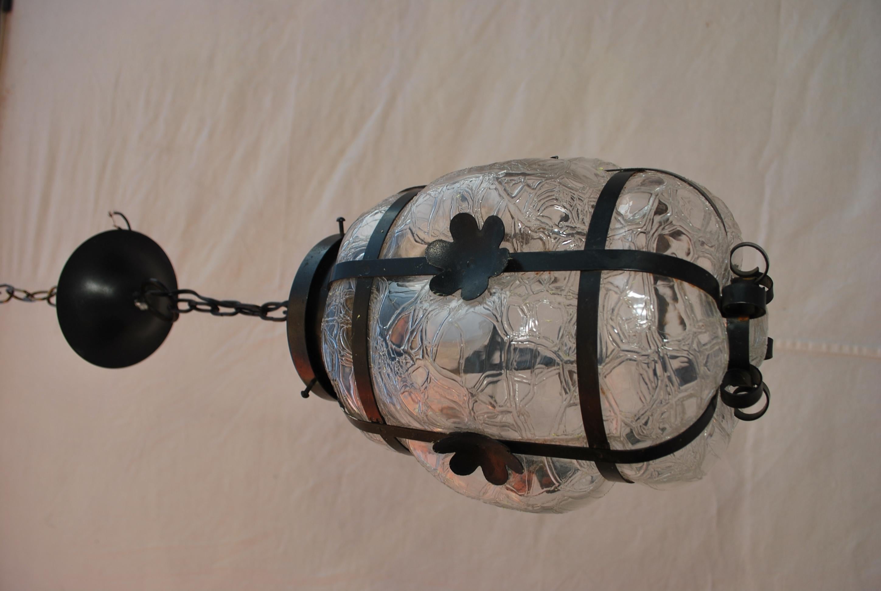A beautiful hands blown glass ( possibly Murano ) light, the glass was blown into the iron frame, the dimensions are with out counting the chain.