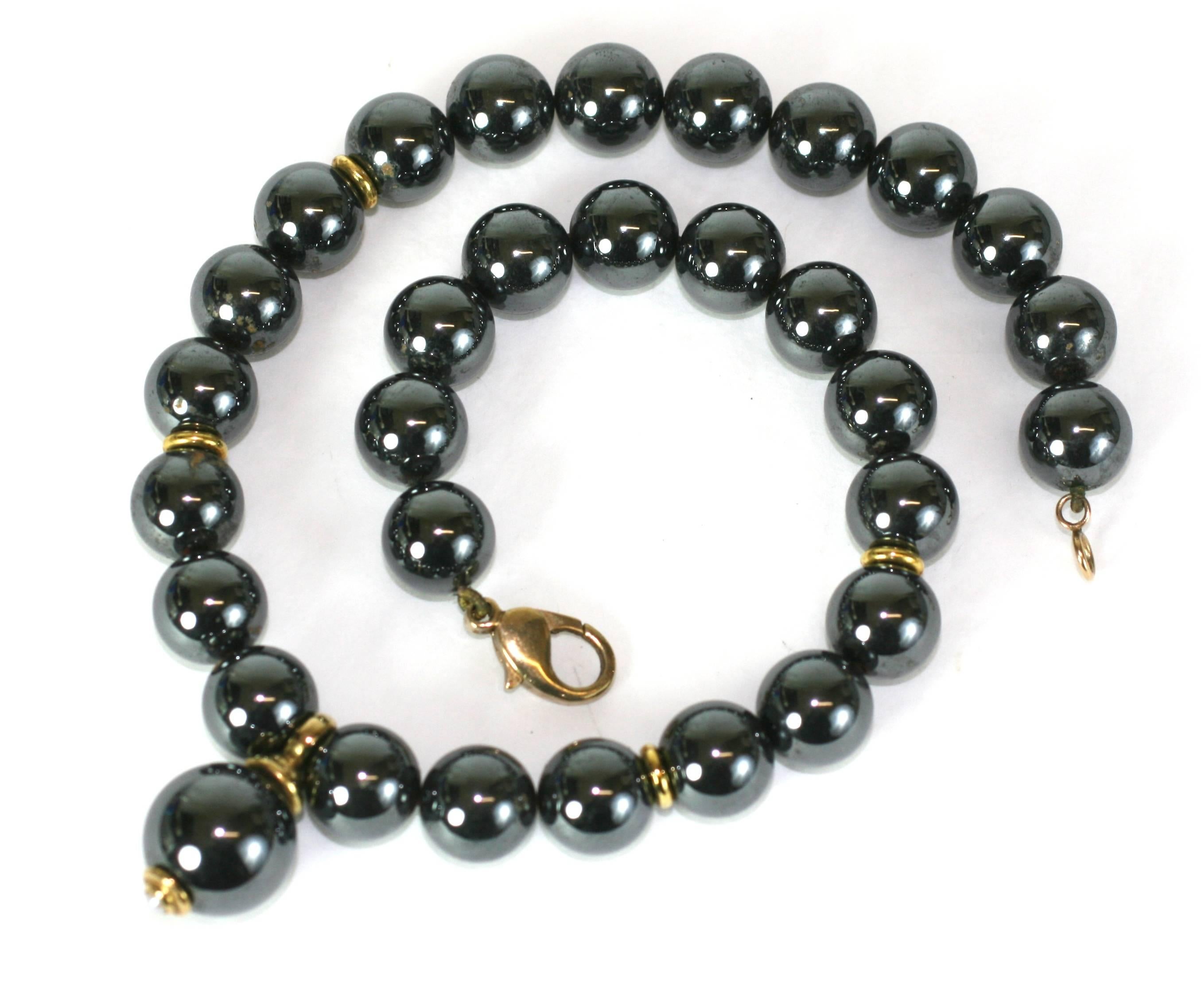 Elegant Hematite and 9k gold fittings with central drop with a pearl cap. Beads are high quality 12mm hematite beads with the larger drop measuring 1