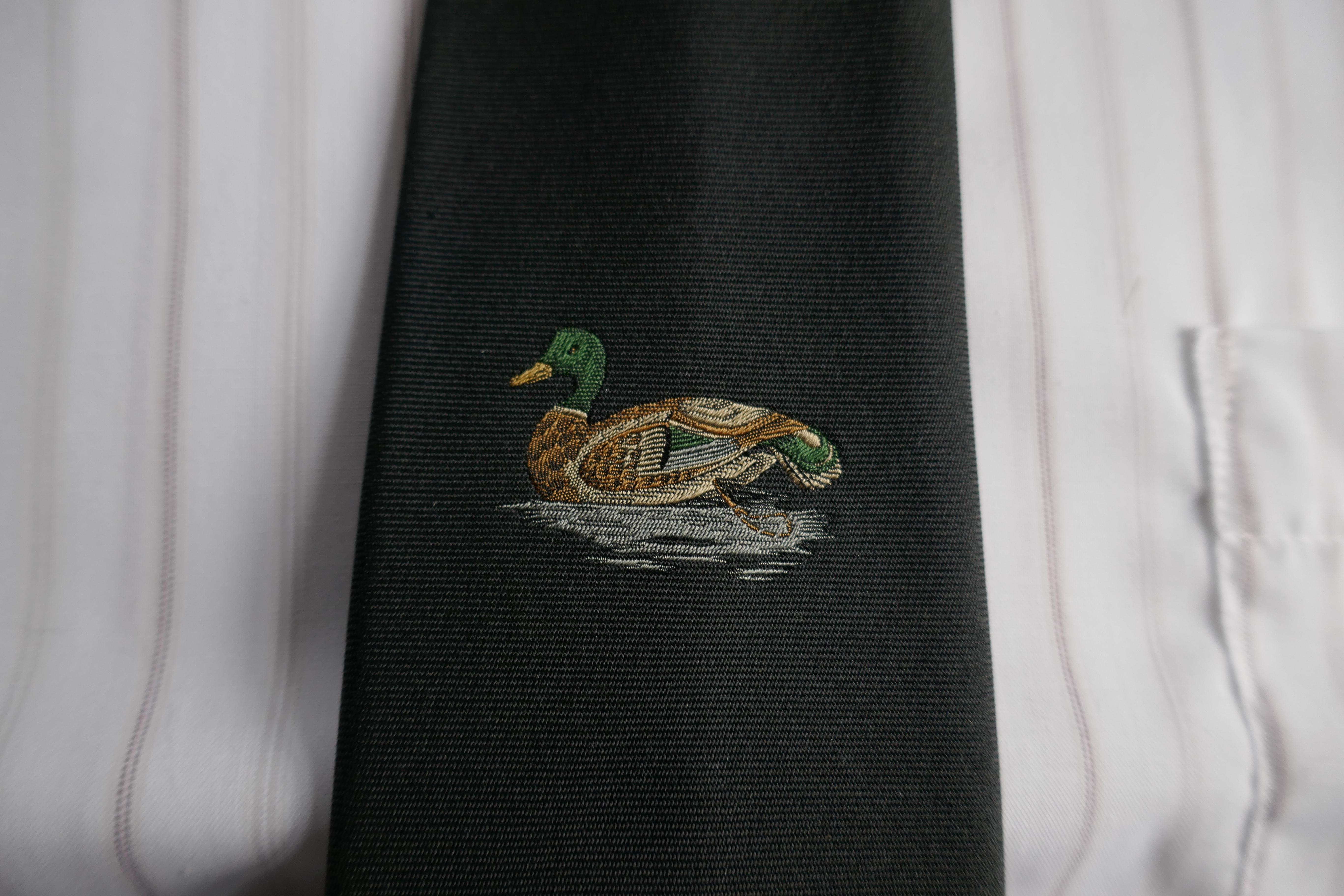 Elegant Hermes Black Silk Tie, Lone Mallard in the Reeds 

Classic Hermes Black Silk Tie with a fine embroidery of a swimming duck 
Superb Tie is lined with H H silk fabric
A Very Special tie, instantly recognisable as Hermes by those in the