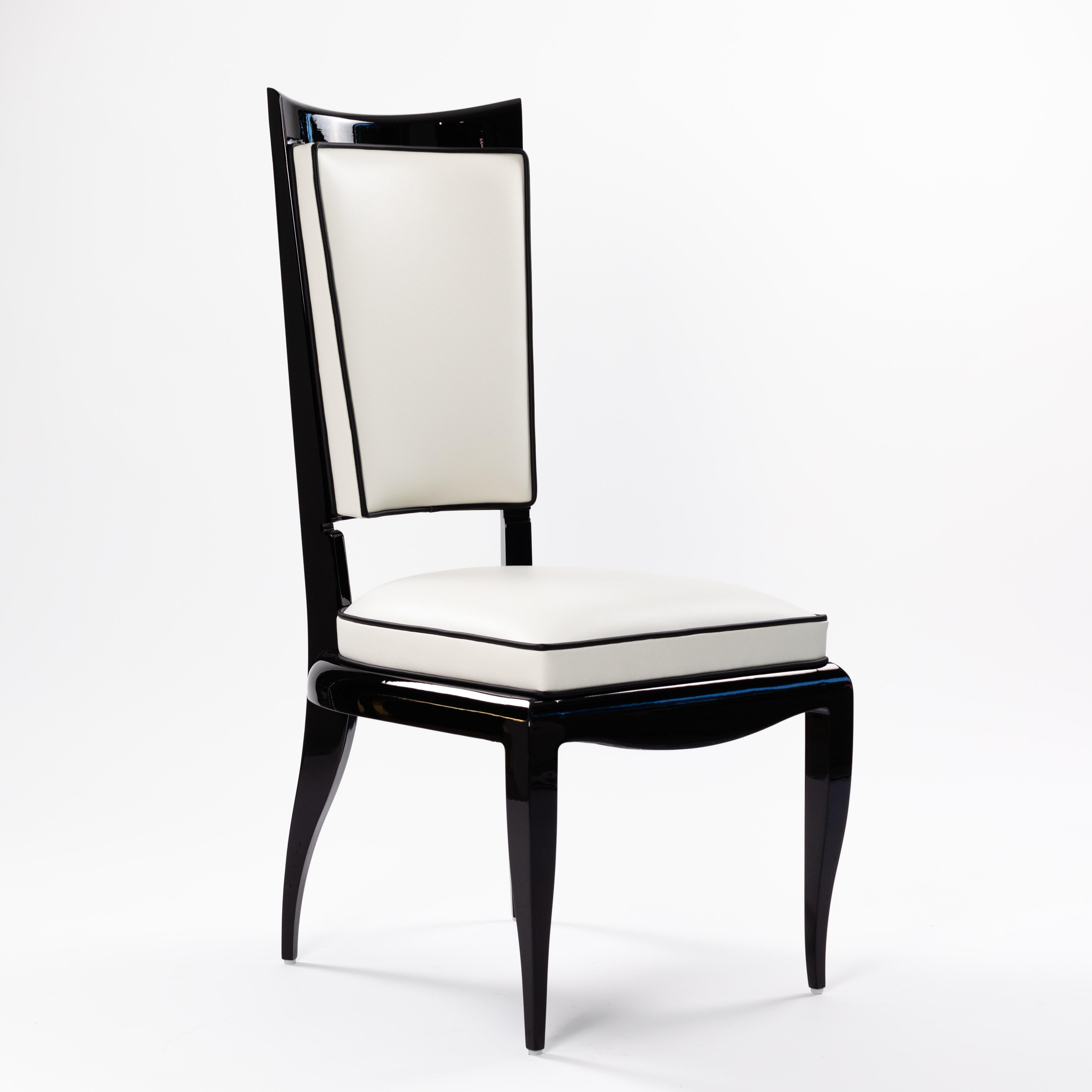 Elegant Art Deco high back chair high gloss black lacquer covered with white nappa leather and black piping.
The chair is a re-edition of an original French Art Deco chair, it is very comfortable and has a sophisticated appearance.
The back of the