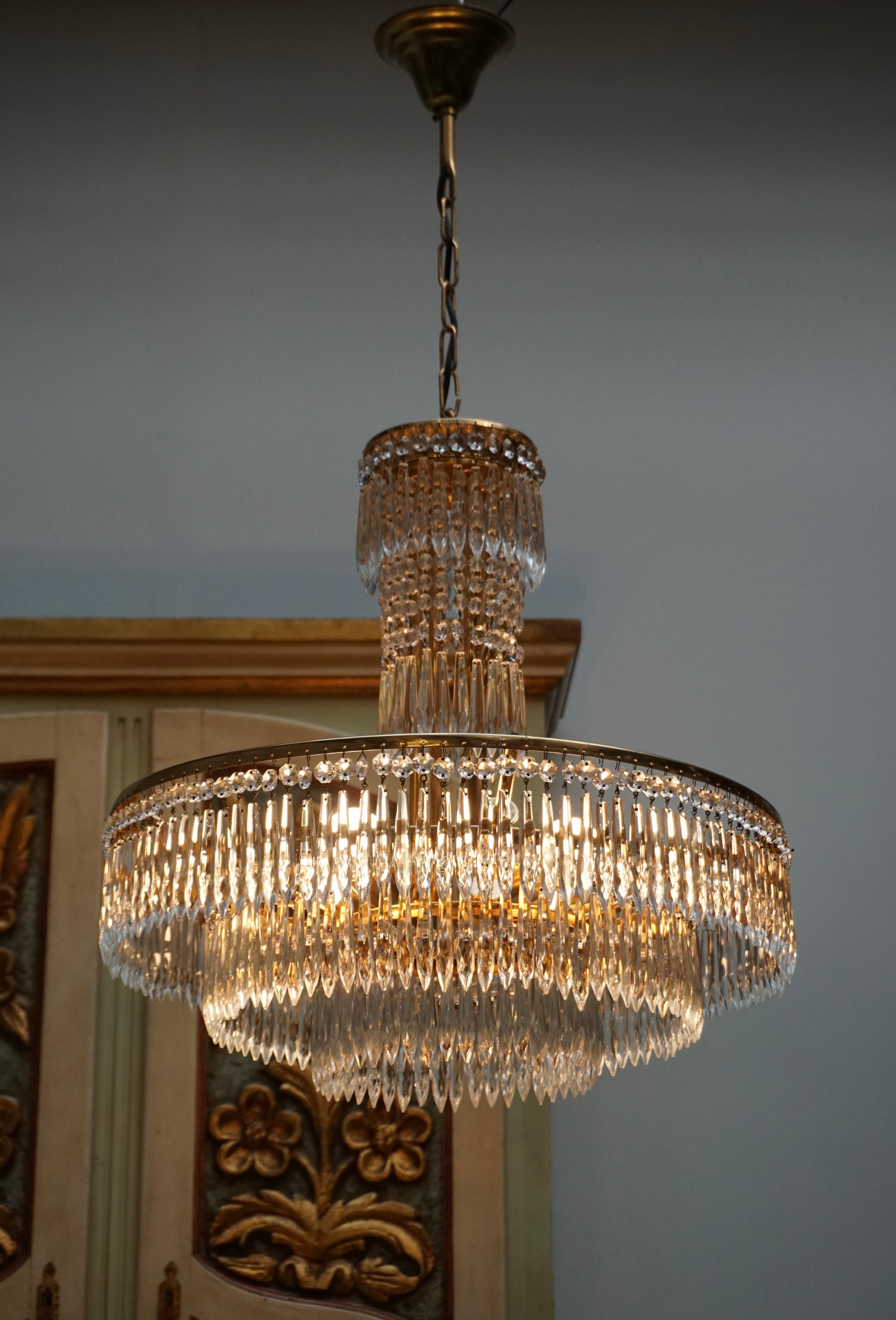 Elegant, Italian crystal and brass chandelier in good working condition.

The light requires four single E27 screw fit lightbulbs (60Watt max.) LED compatible. 
Measures: Diameter 52 cm. 
Height fixture 52 cm. 
Total height with chain 85 cm.

  