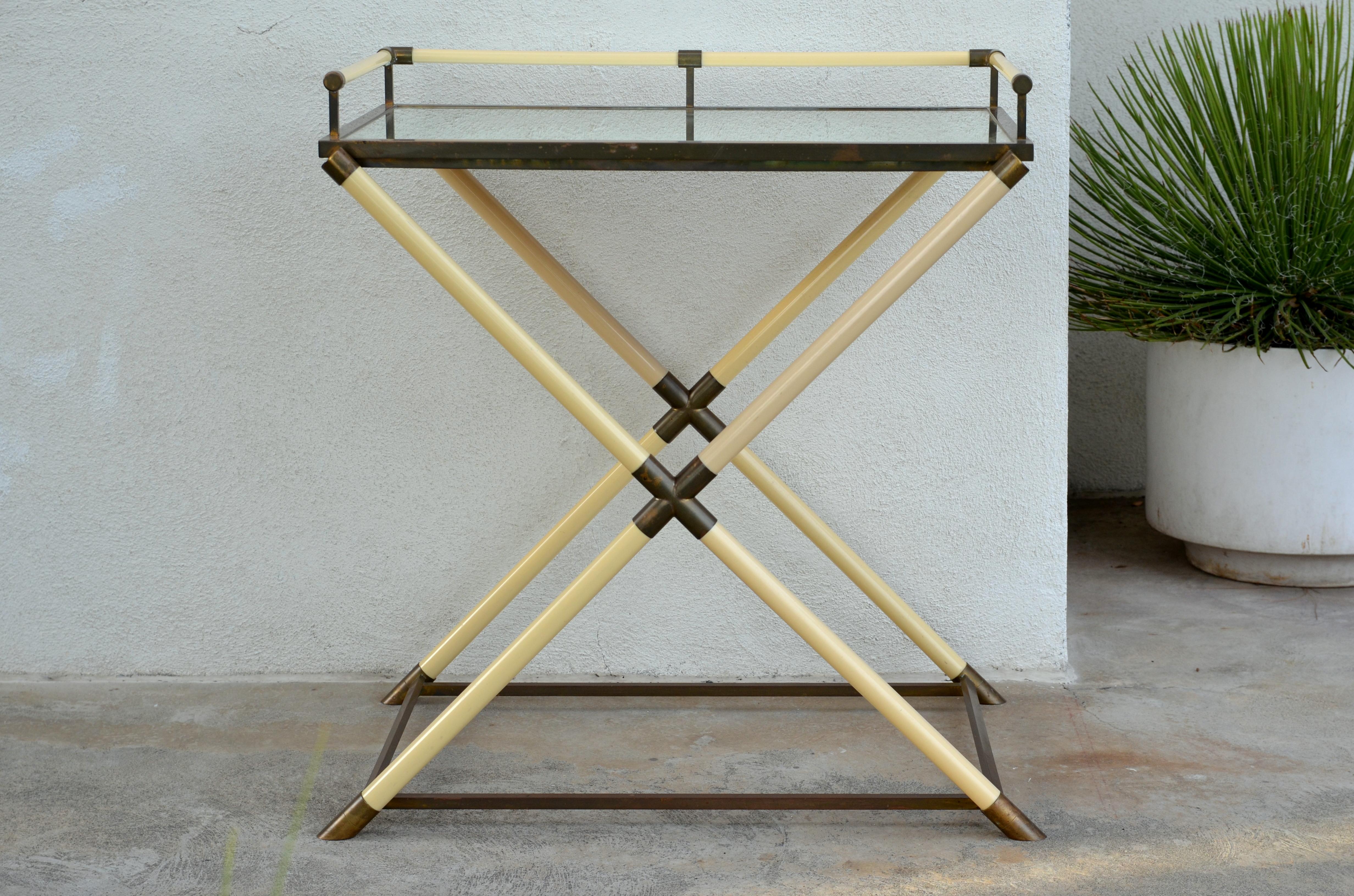 Chic mirrored and patinated brass bar cart by Maison Jansen, Paris. Attractive X stretcher design with removable tray for serving. Also great as a console.

The tray is 32 in. from the floor.