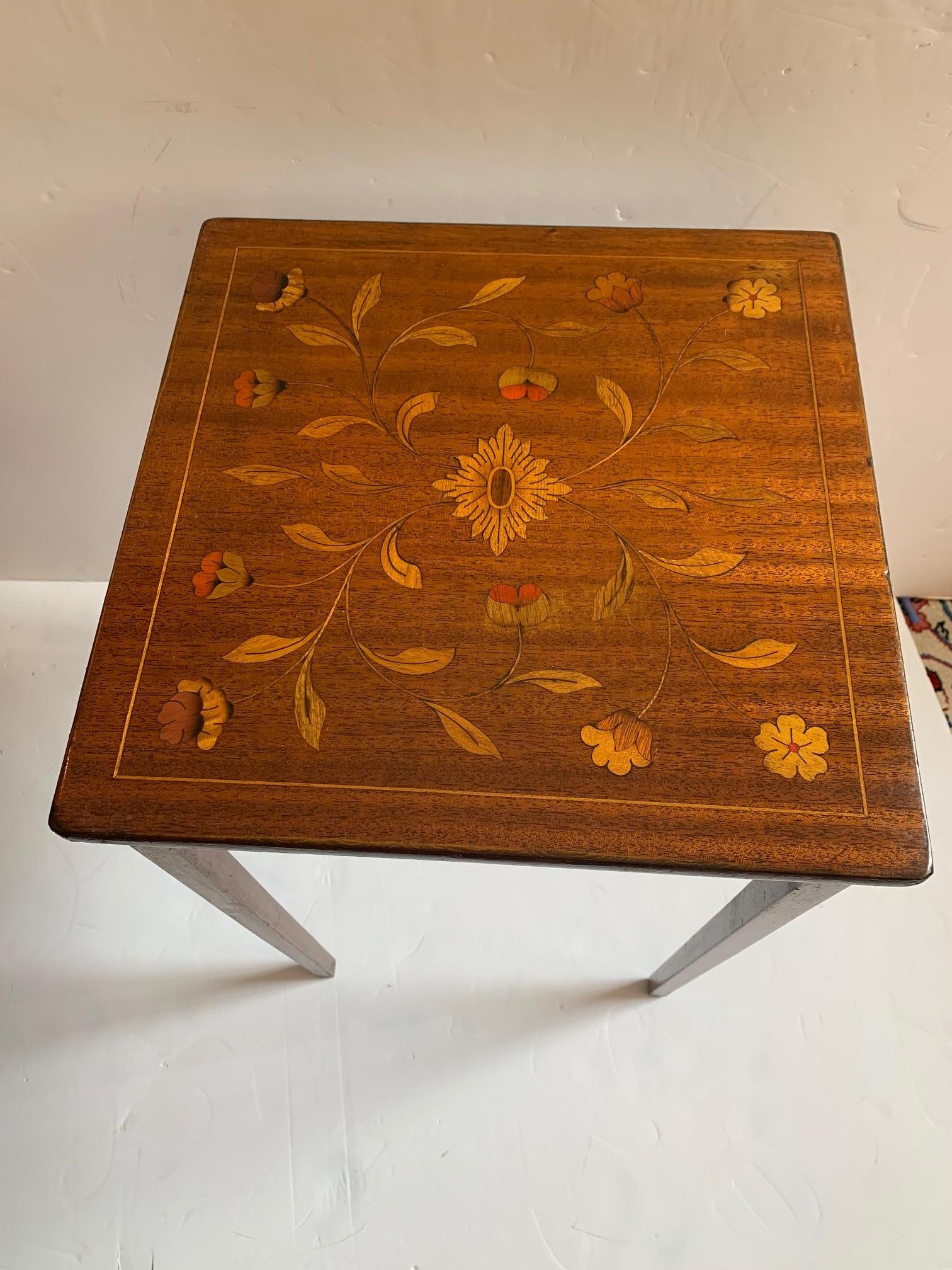 A diminutive square end table having lovely inlaid floral decoration and tapered legs.
Larger matching table also available. They do not 